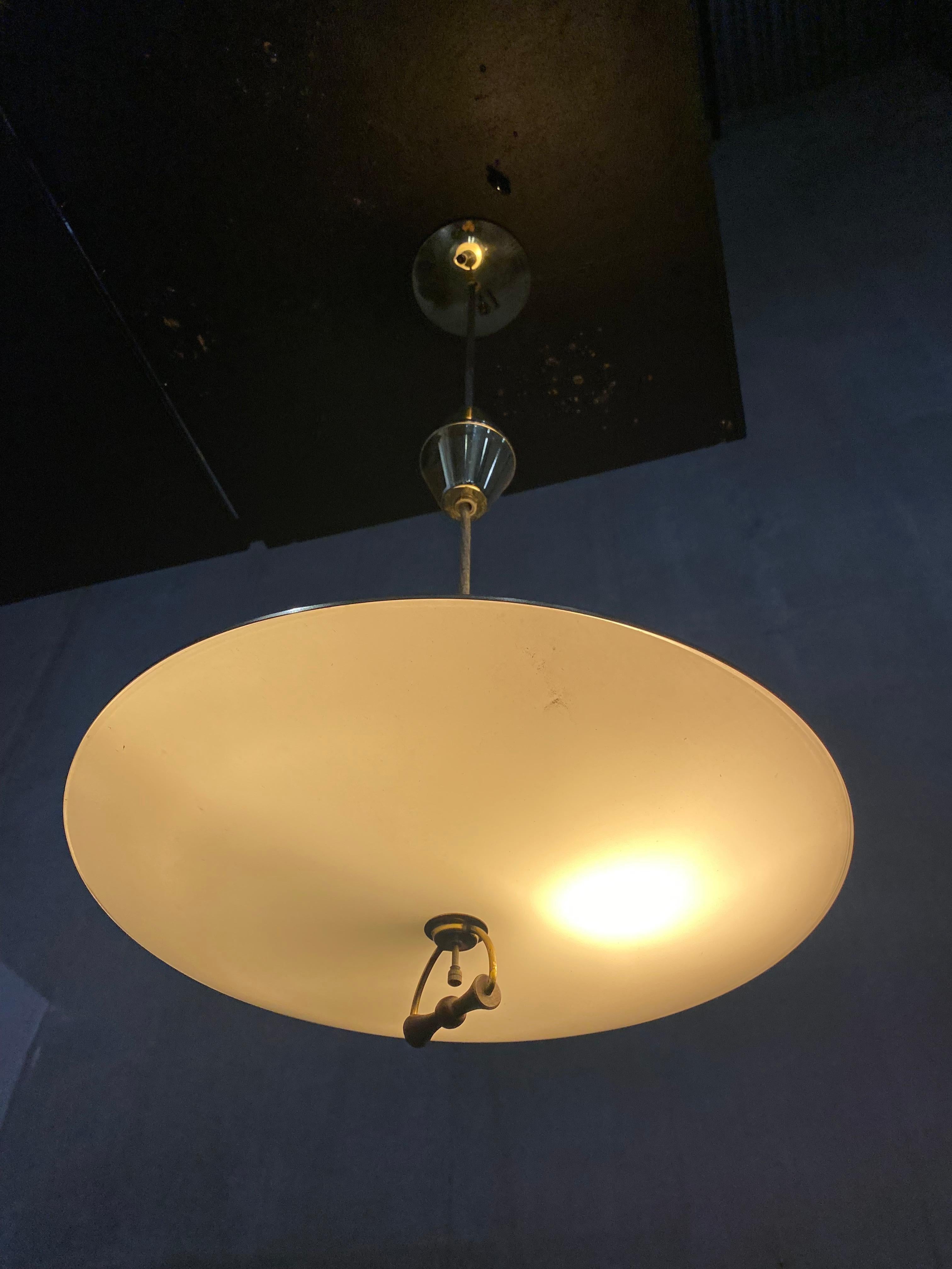 Mid-Century Modern atomic style brass light by Imperialites pull down & retractable pendant chandelier comprised of walnut, brass plate and white glass shade. 
recently acquired from home demolished in Seattle built in 1960.
Shade allows for light