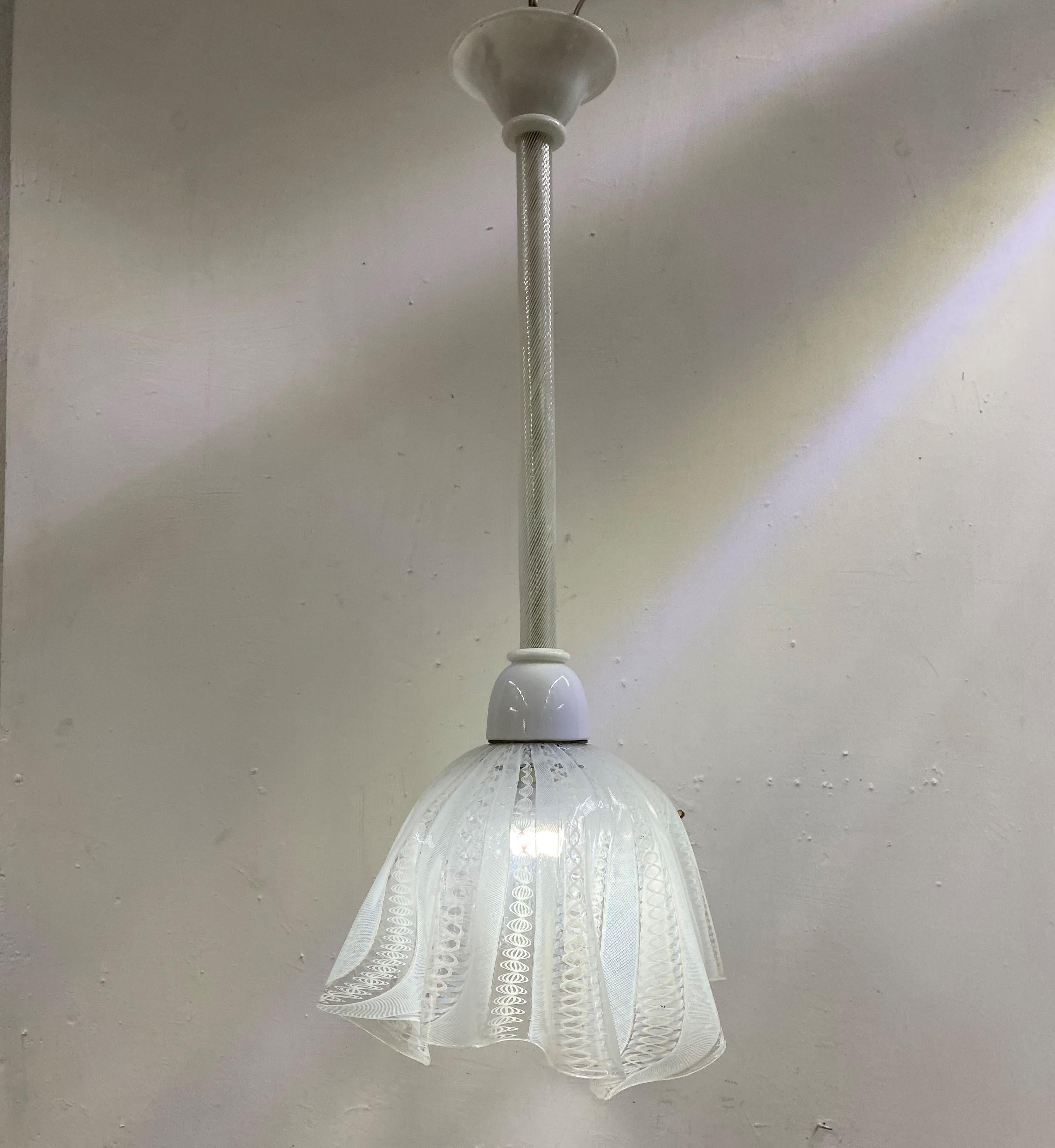 Beautiful Mid-Century Modern pendant light or lantern designed by Fulvio Bianconi for Venini in white Murano glass.
The shade of the chandelier is called 