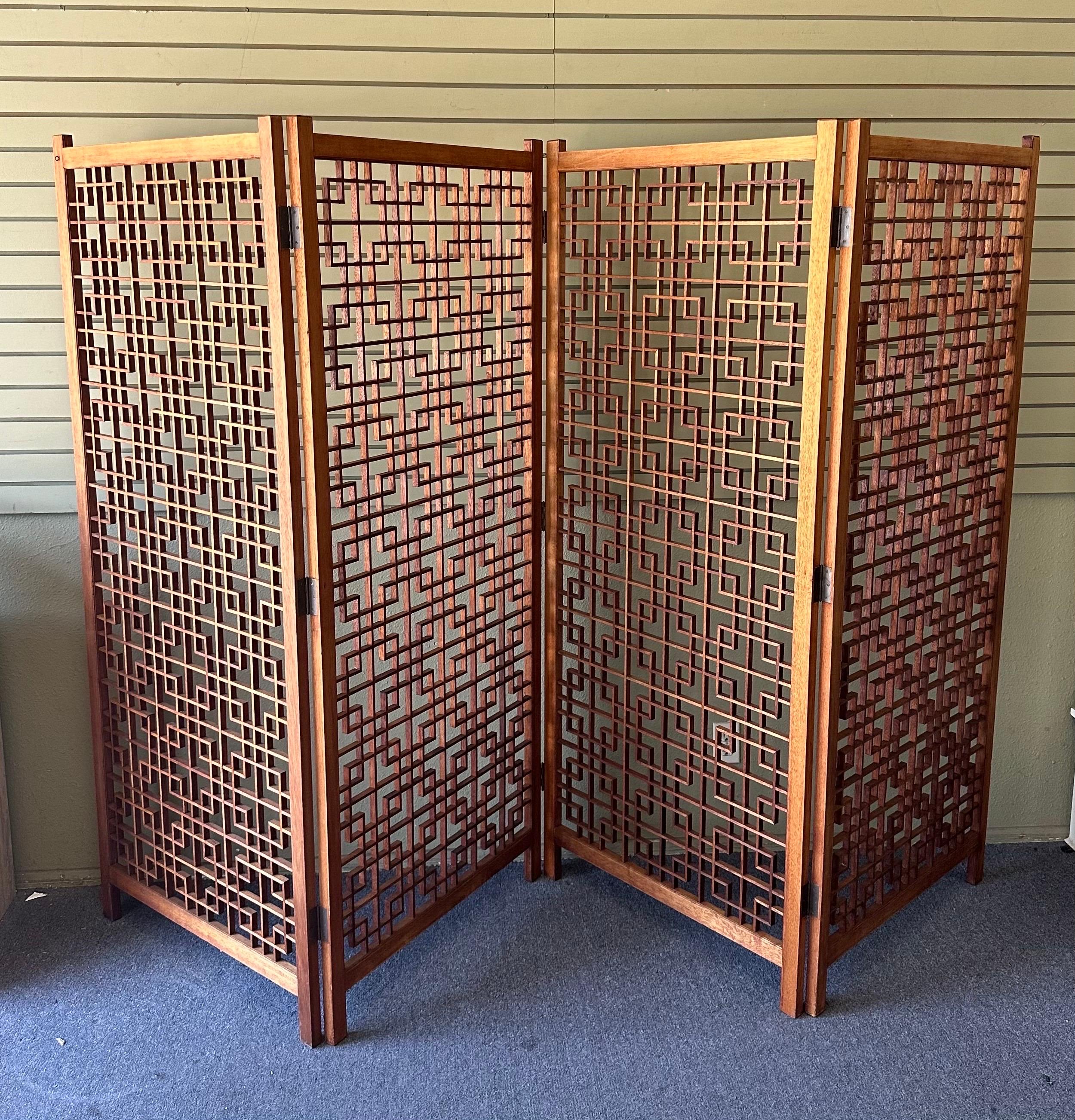 A very cool and hard to find four panel teak folding screen with intricate square lattice design, circa 1970s. Each individual panel measures a substantial 30