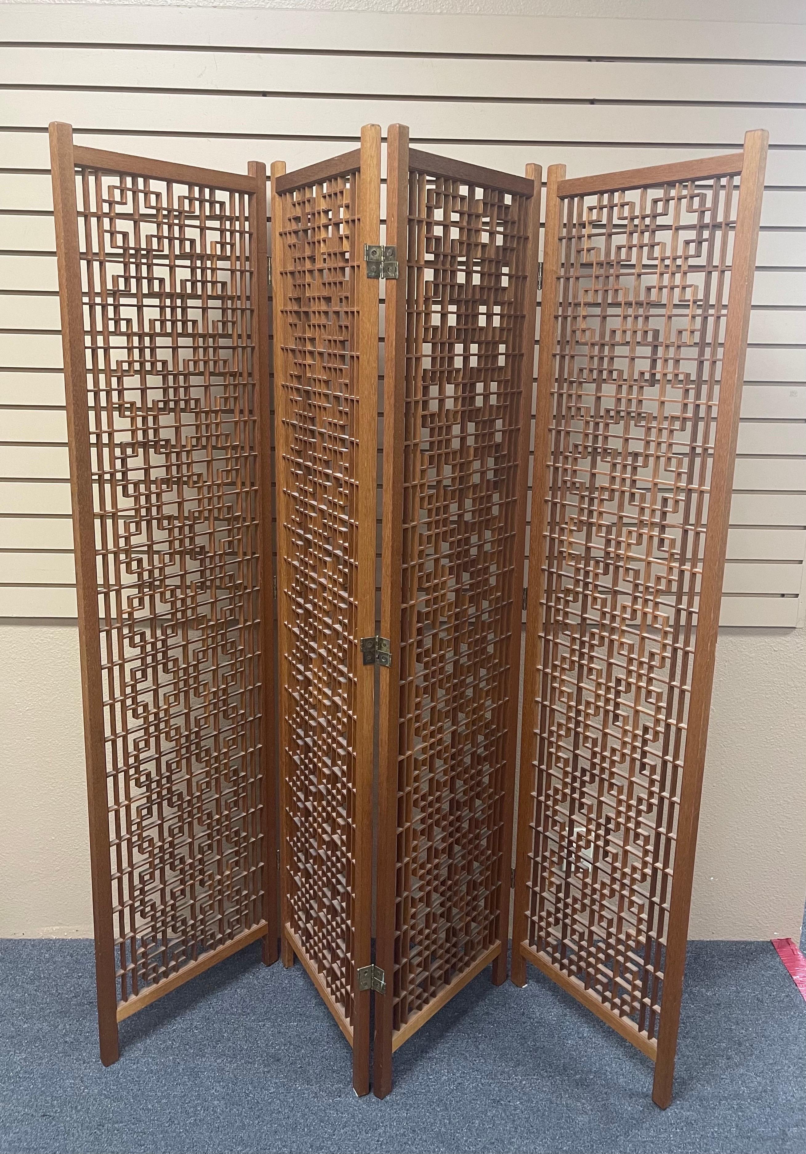 A very cool four panel teak folding screen with intricate lattice design, circa 1970s. Each individual panel measures 17