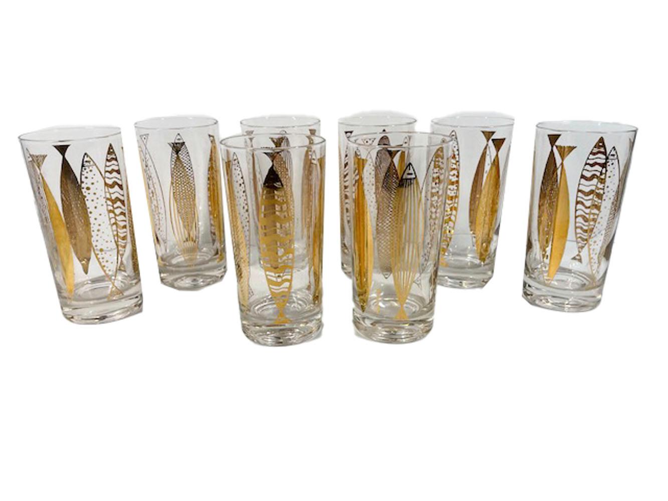 Eight Mid-Century Modern highball glasses designed by Fred Press, with 22k gold fish in six different abstract patterns, vertically placed around each glass.