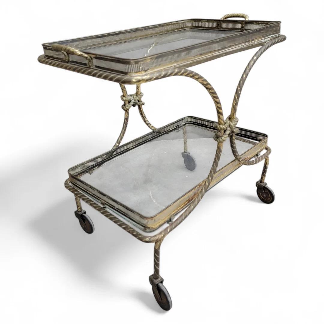 Mid Century French Bagues Style Brass Rope Bar Cart on Wheels with Removable Tray

This Mid Century French Bagues Style Brass Rope Bar Cart combines elegance and functionality, making it an ideal addition to any sophisticated space. Crafted with a