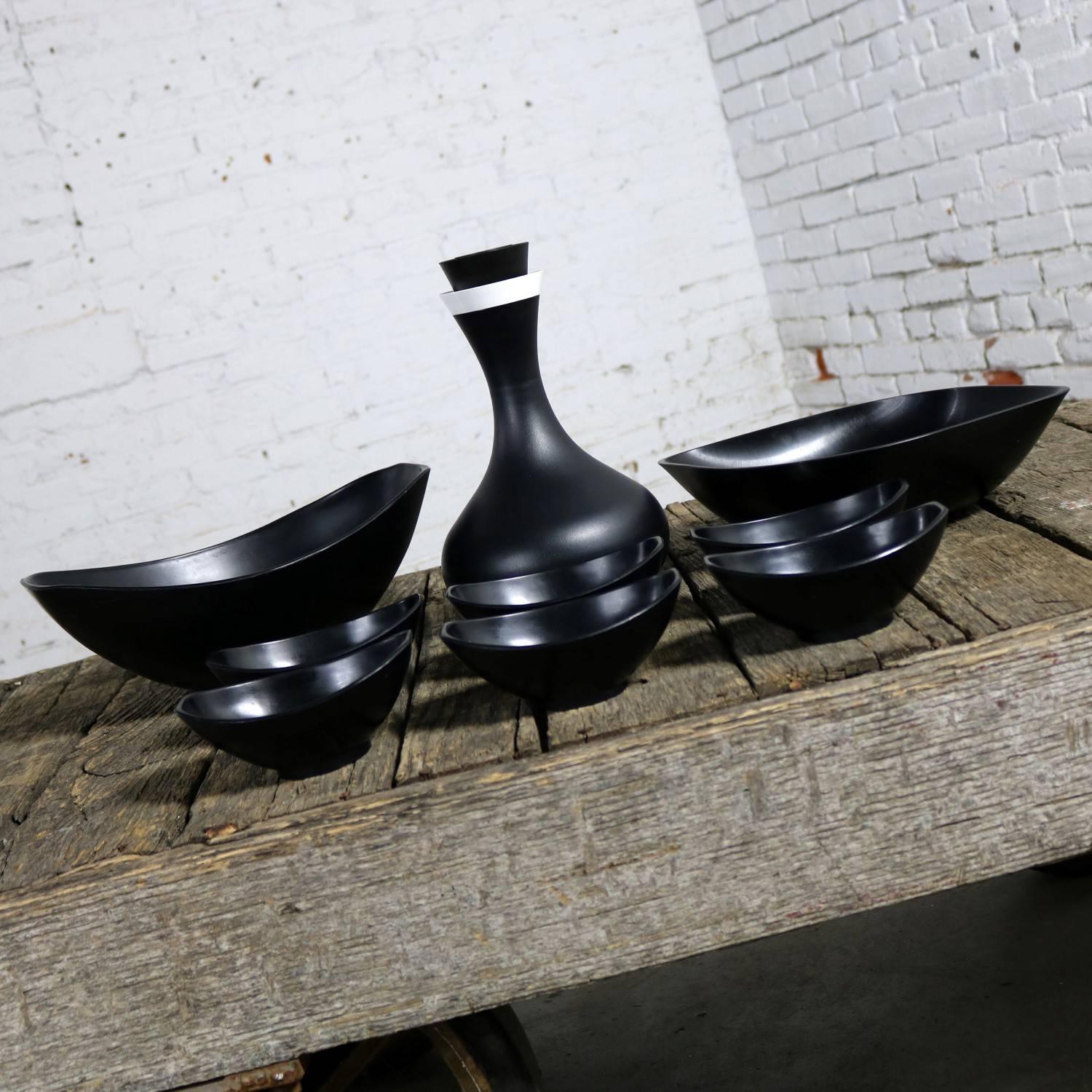 Fun black plastic MCM serving pieces consisting of a Mid-Century Modern Genie server carafe in black by David Douglas for David Douglas and Co., Inc of Manitowoc, Wisconsin circa 1966; a Mid-Century Modern salad set in black plastic by Styson Art