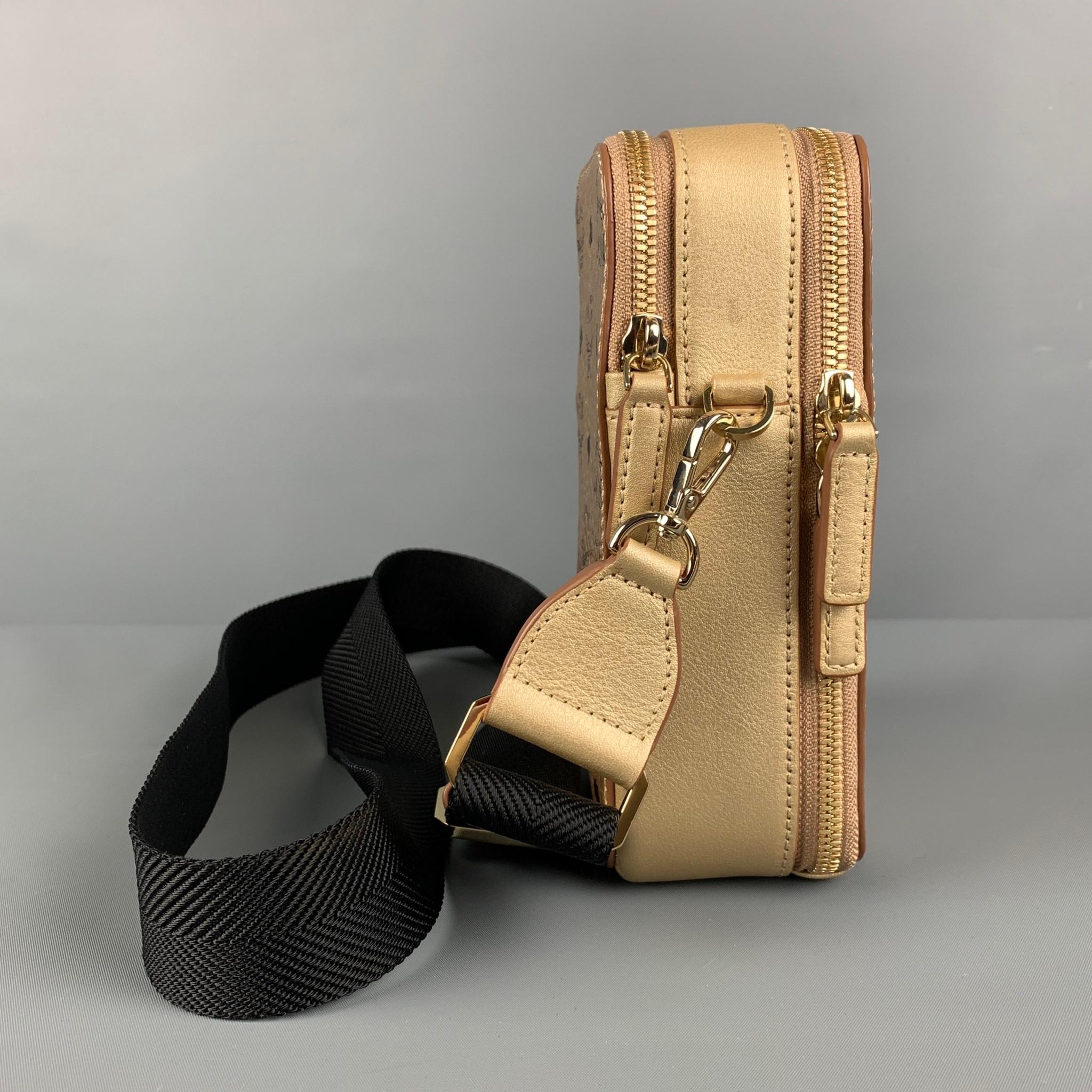 MCM camera bag comes in a gold & black monogram coated canvas featuring a detachable crossbody strap, inner slots, and a zipper closure. Comes with dust bag.

Excellent Pre-Owned Condition.
Marked: 1616R

Measurements:

Length: 4 in.
Width: 2.5