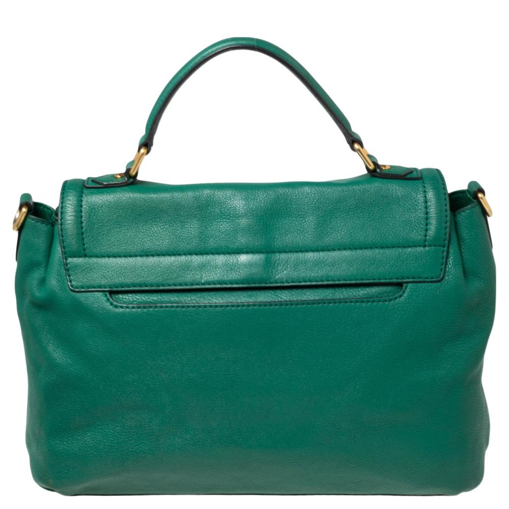 This MCM handbag is a fashion ally that never fails to increase your glamour quotient. The green leather body of this bag gives off a sophisticated look. It comes with a top handle and the front flap opens to a fabric-lined interior.

Includes:
