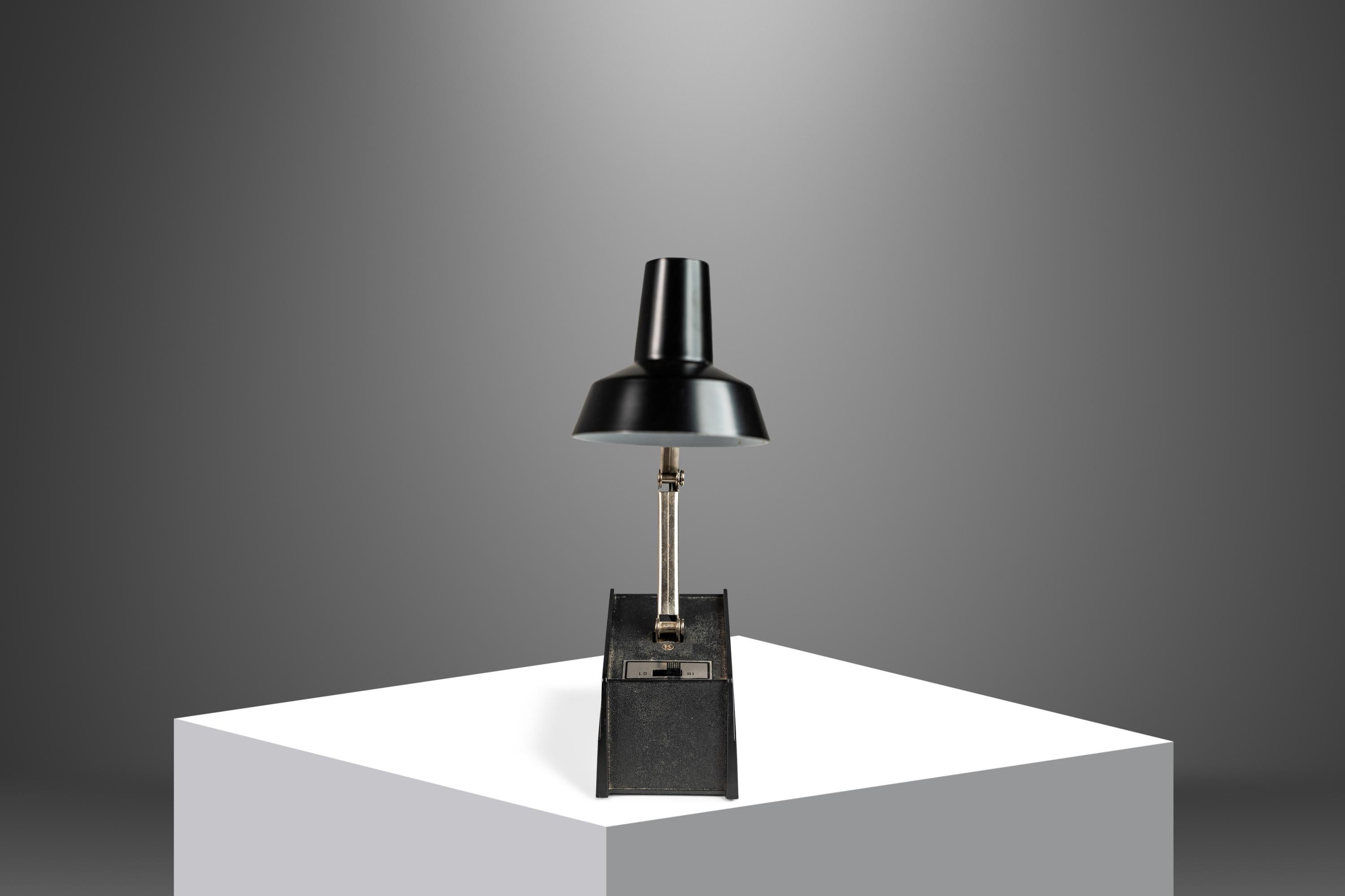 Tensor adjustable desk or table lamp with perfect 1970's styling is small in size but great for tight space for its small footprint. Enameled base and shade, chrome stem, with adjustable height and angle. Works perfectly and in excellent vintage