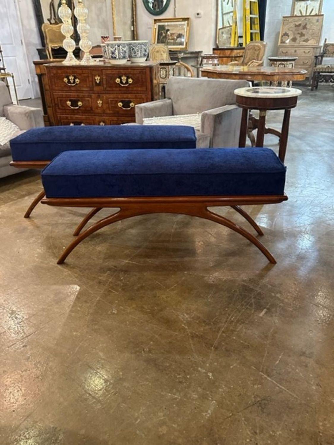 Handsome MCM style mahogany benches upholstered in a blue fabric. Nice clean lines and good quality.  Note: These are priced per item.
