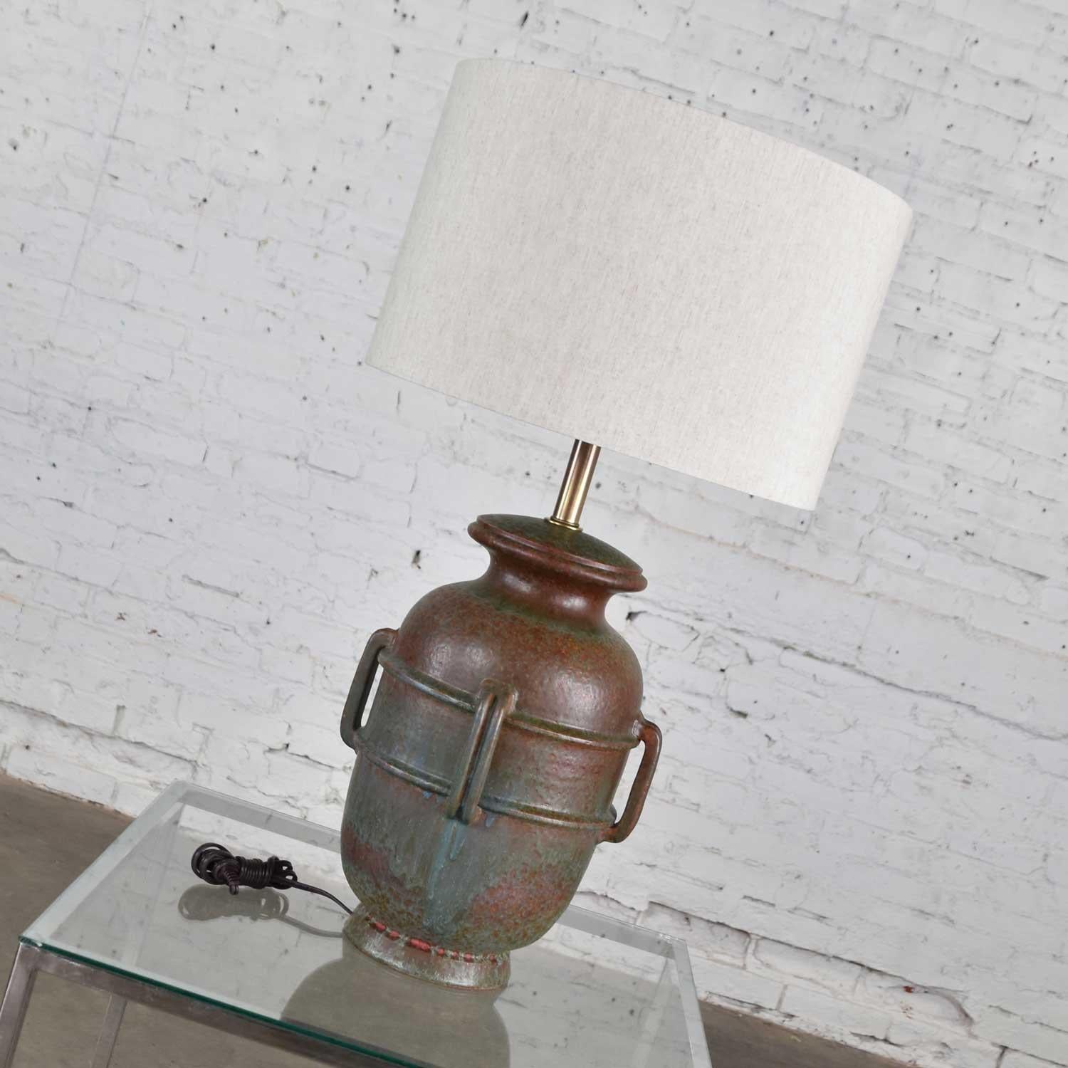 Very handsome large Mid-Century Modern Italian green mottled pottery lamp marked Raymor Italy and attributed to Alvino Bagni. It is in fabulous vintage condition. It has new wiring, socket, and off-white linen drum shade. Please see photos, circa