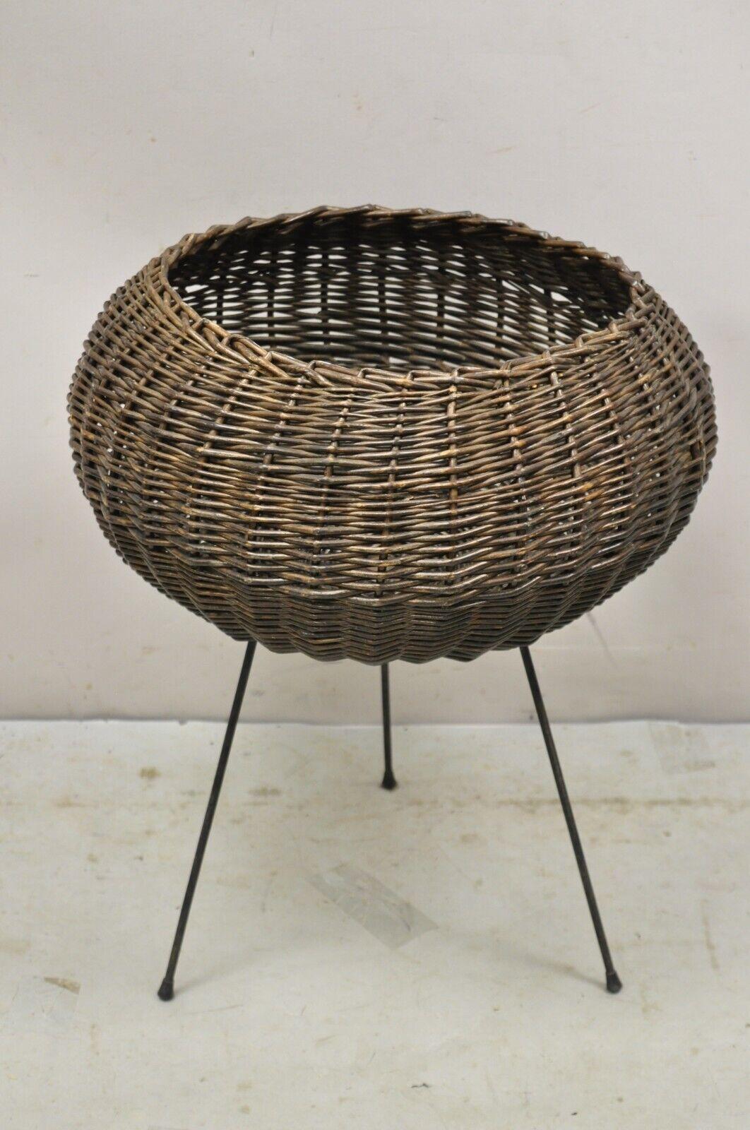 Mid Century Modern Italian Round Wicker Rattan Wrought Iron Planter Stand Arthur Umanoff Style. Item features wrought iron tripod base, round wicker basket, great for use as a storage basket or planter stand, very nice vintage item, clean modernist
