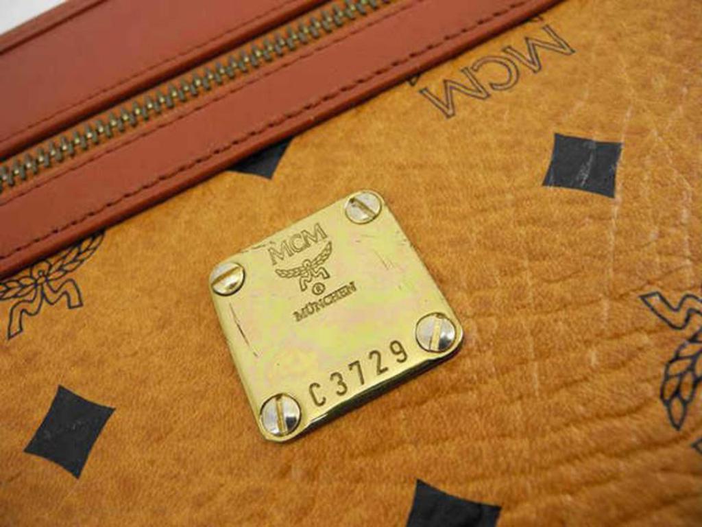 MCM Large Cognac Monogram Visetos 230971 Brown Coated Canvas Clutch In Good Condition For Sale In Forest Hills, NY