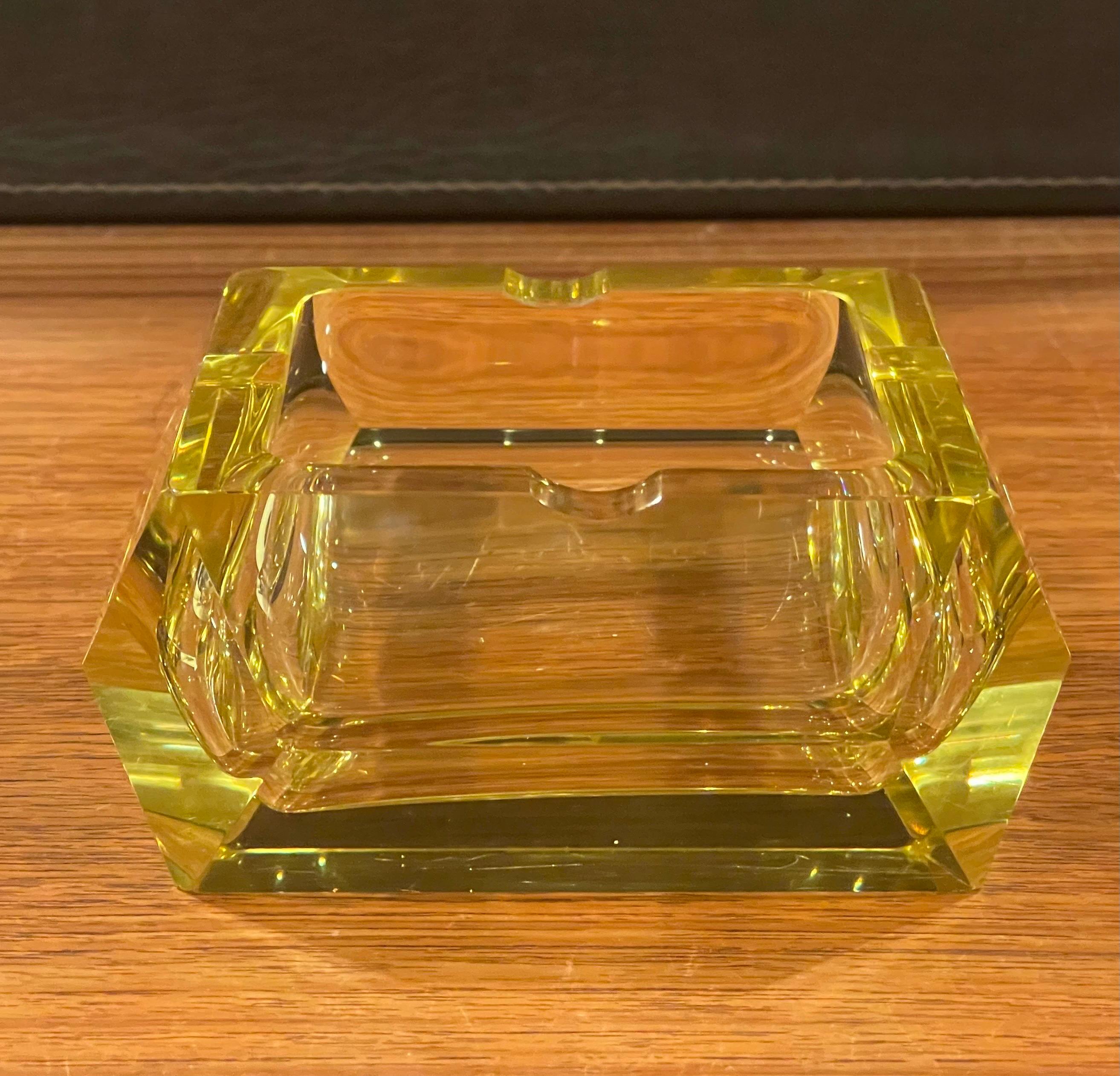 yellow glass ashtray