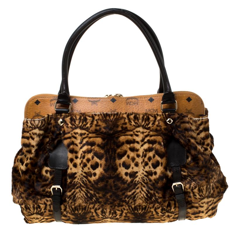 MCM's tote will instantly add style and edge to your look. It is made in calfhair carrying a leopard print and detailed with a coated canvas panel on top. It comes with dual handles and the zip top closure opens to a fabric lined interior equipped