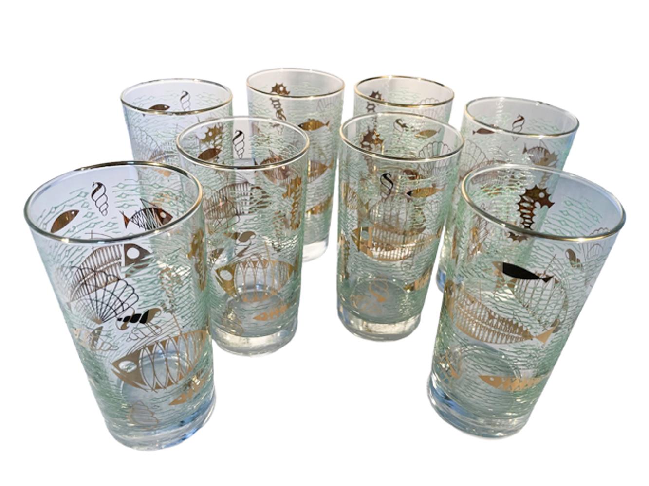 Set of 8 Libbey glass highball glasses in the 'Marine Life' pattern having atomic design fish in 22k gold on a ground of raised translucent green 'waves'. Libbey discontinued this pattern in 1959.