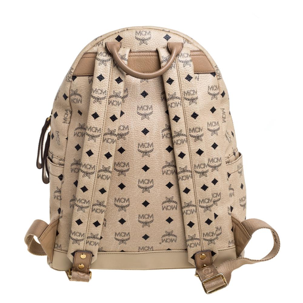 This stunning MCM backpack will come in handy for daily use or as a style statement. It is crafted from signature coated canvas and designed with stud embellishments, a front pocket and a spacious interior secured by a zipper. Two shoulder straps