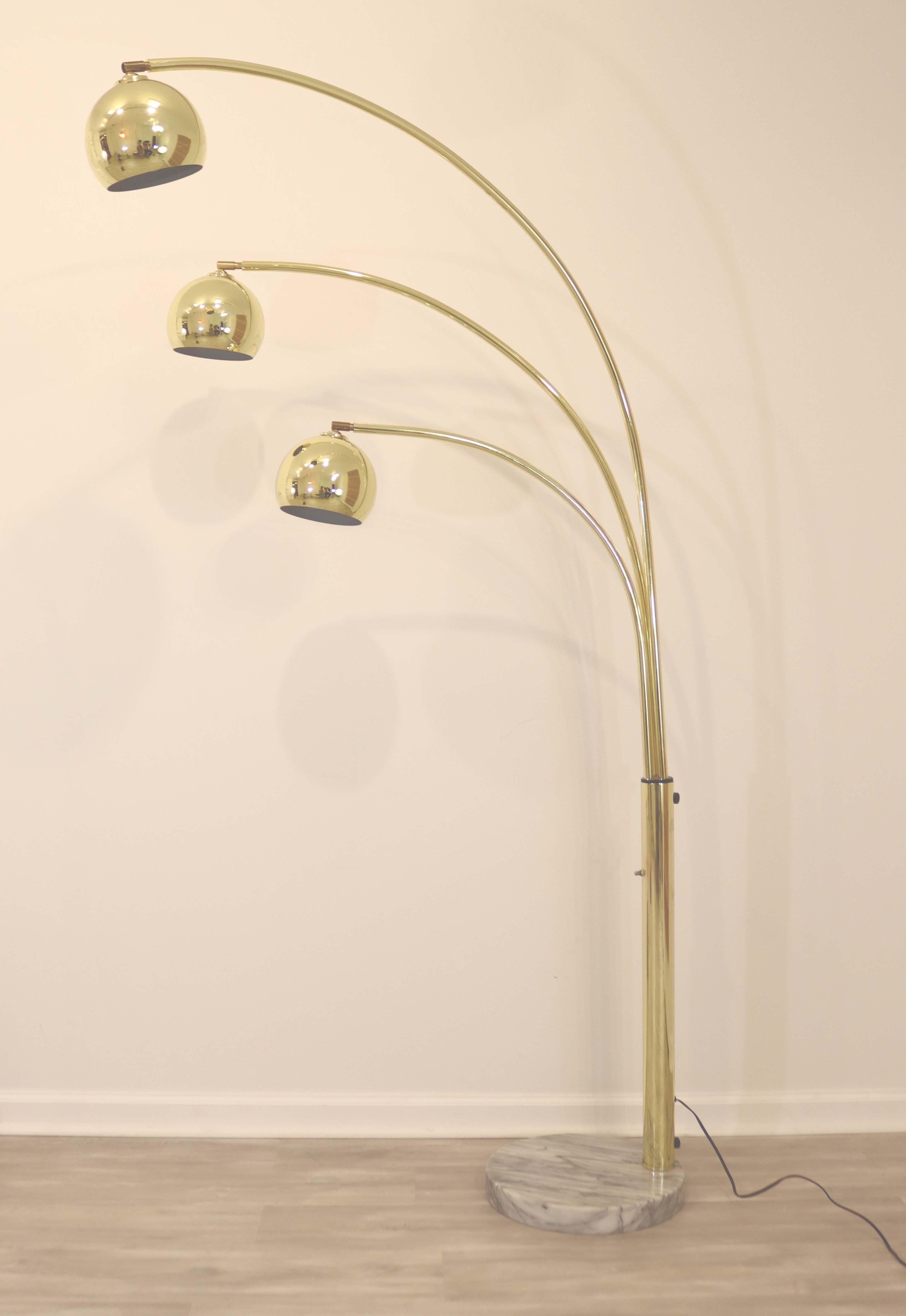 This brass arc floor lamp circa the 1970's is in great condition and features 3 adjustable arms that swing independently, while each light articulates in nearly any direction and is stabilized by a decorative marble base. A fantastic addition to any