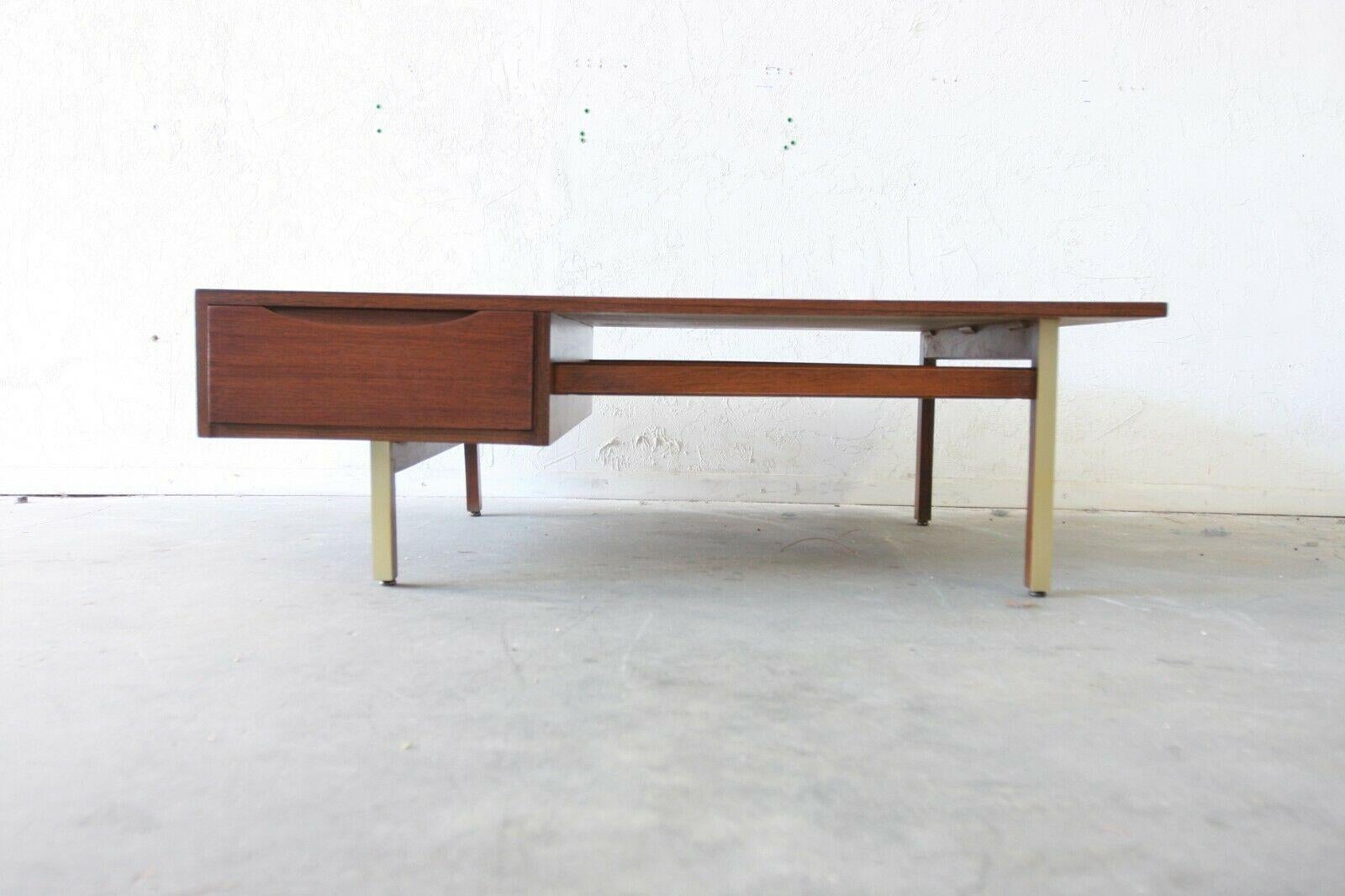 Beautiful professionally refinished Mid-Century Modern American of Martinsville walnut coffee table with brass accented legs. Squared off design with pull out drawer and finished backside.

Dimensions:

49