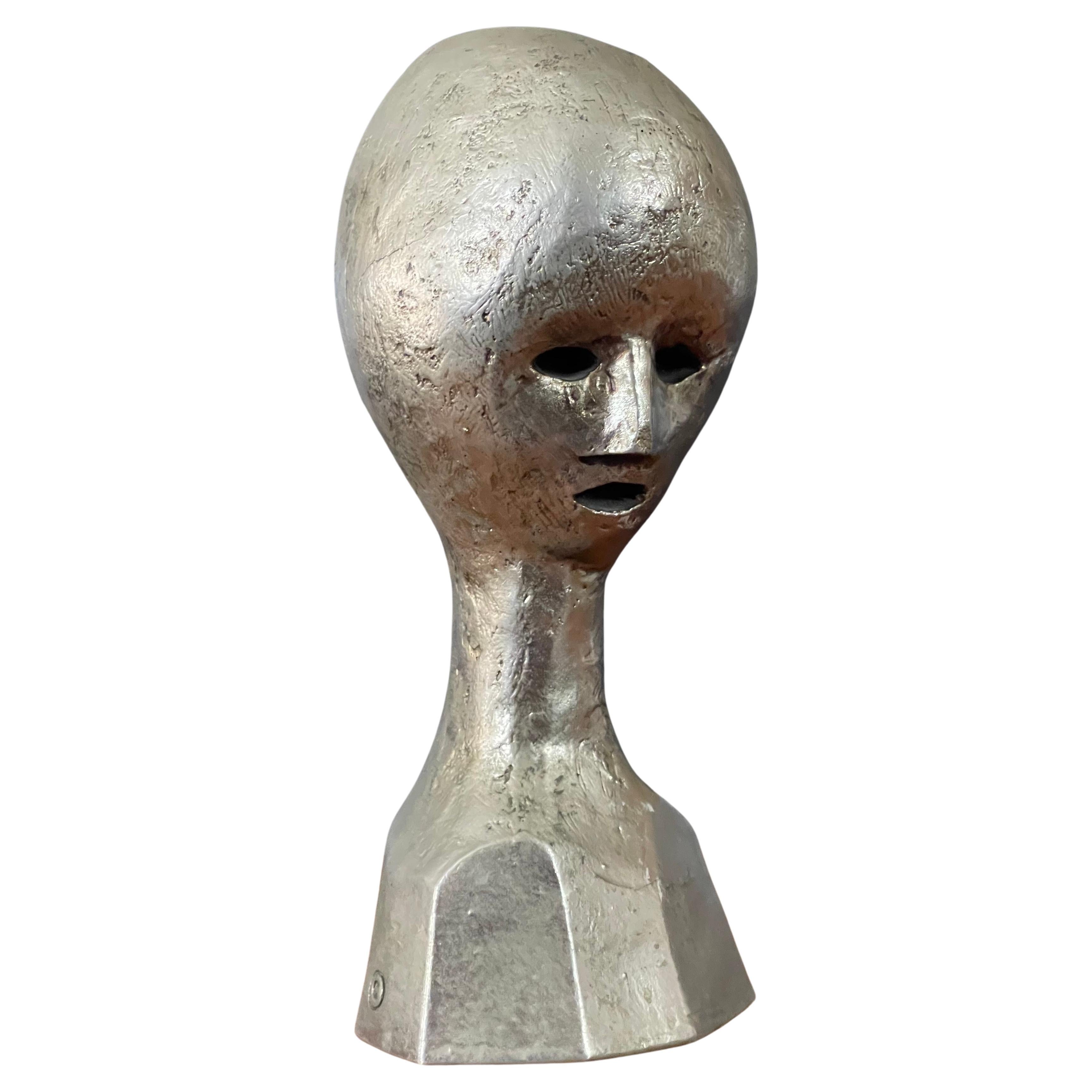 A very cool MCM modernist alien bust / head sculpture by Andre Minaux, circa 1970s. This rare sculpture by noted French designer Andre Minaux is made of cast metal over bronze with a silver wash finish and is in very good vintage condition with no