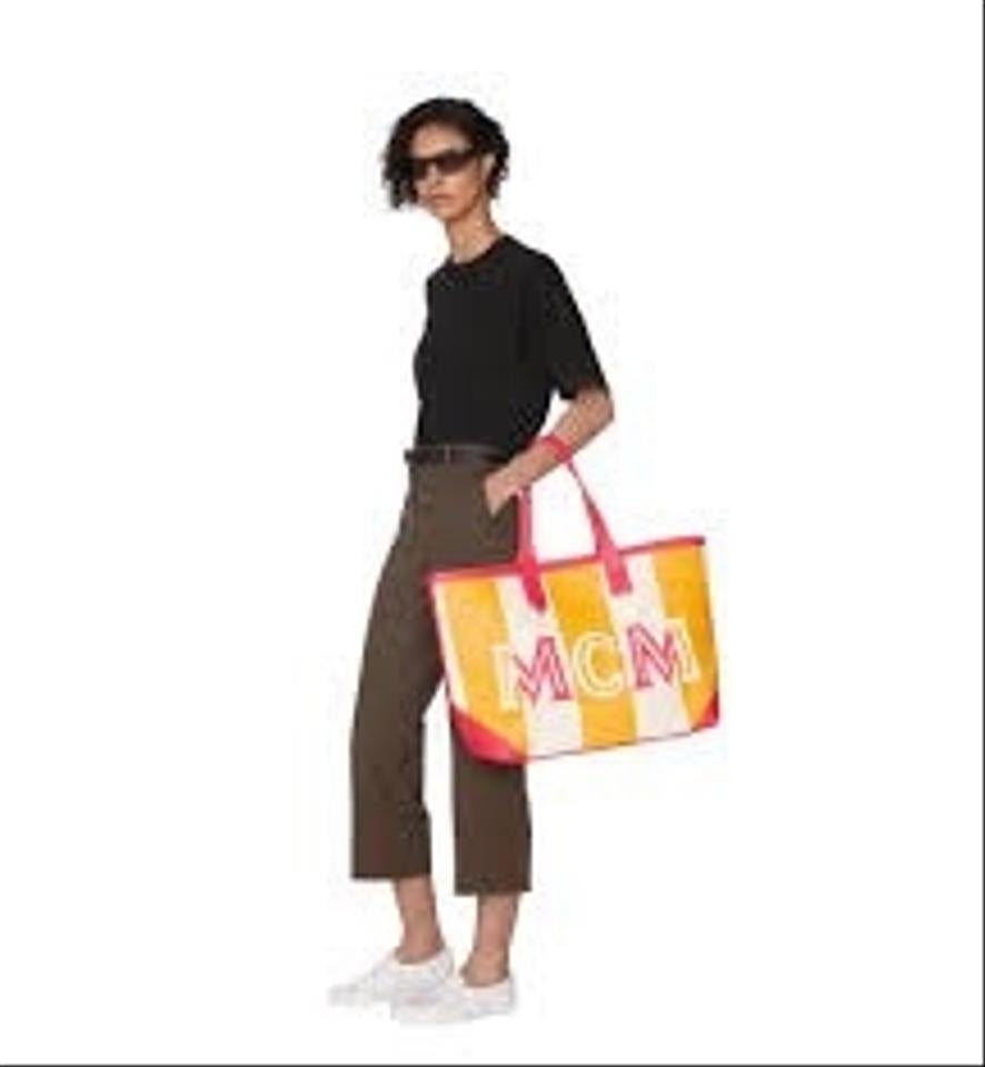 Turn your day of shopping into a day of fashion carrying the MCM™ Ilse Canvas Shopper Large Shopper.
 Shopper made of durable, color-blocked canvas.
 Spacious top opening with centered, magnetic snap button closure.
 Signature brand name initials