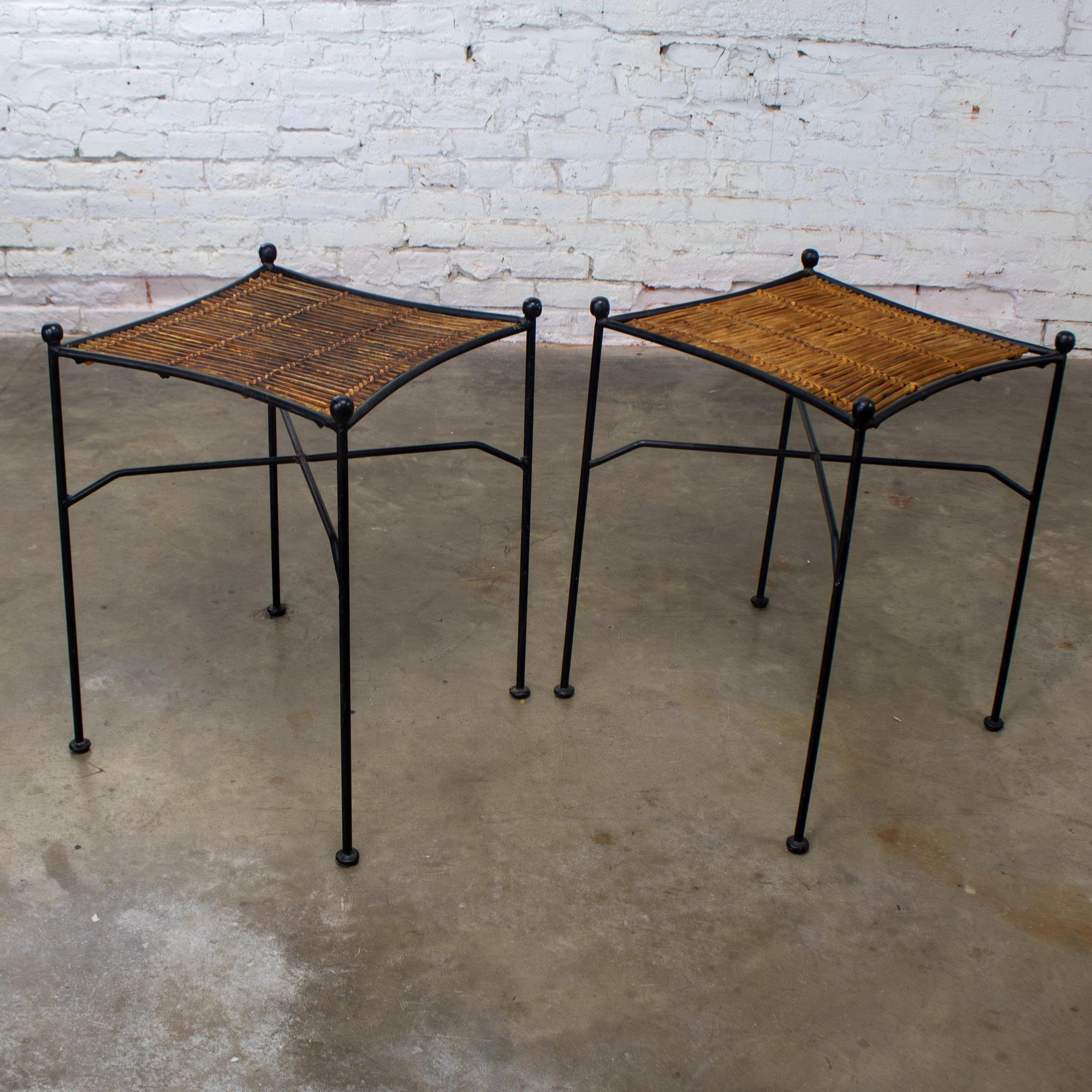 Marvelous vintage MCM or Mid-Century Modern pair of end tables attributed to Eva-Lisa (Pipsan) Saarinen Swansen for Ficks Reed Sol-Air Line composed of black painted wrought iron frames & woven reeded natural rattan tabletops. These pieces have