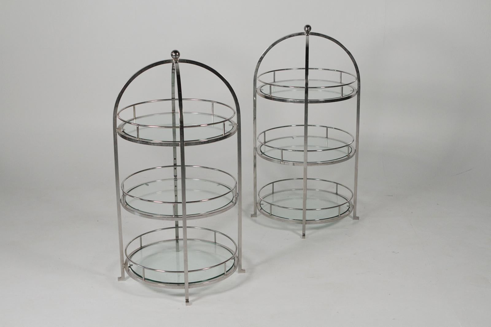 MCM pair of chrome and glass side tables, three-tiered glass with chrome-plated steel frames. These would work as side tables or as servers on a large dining table or sideboard. Solid welded steel frames, chrome-plated.
