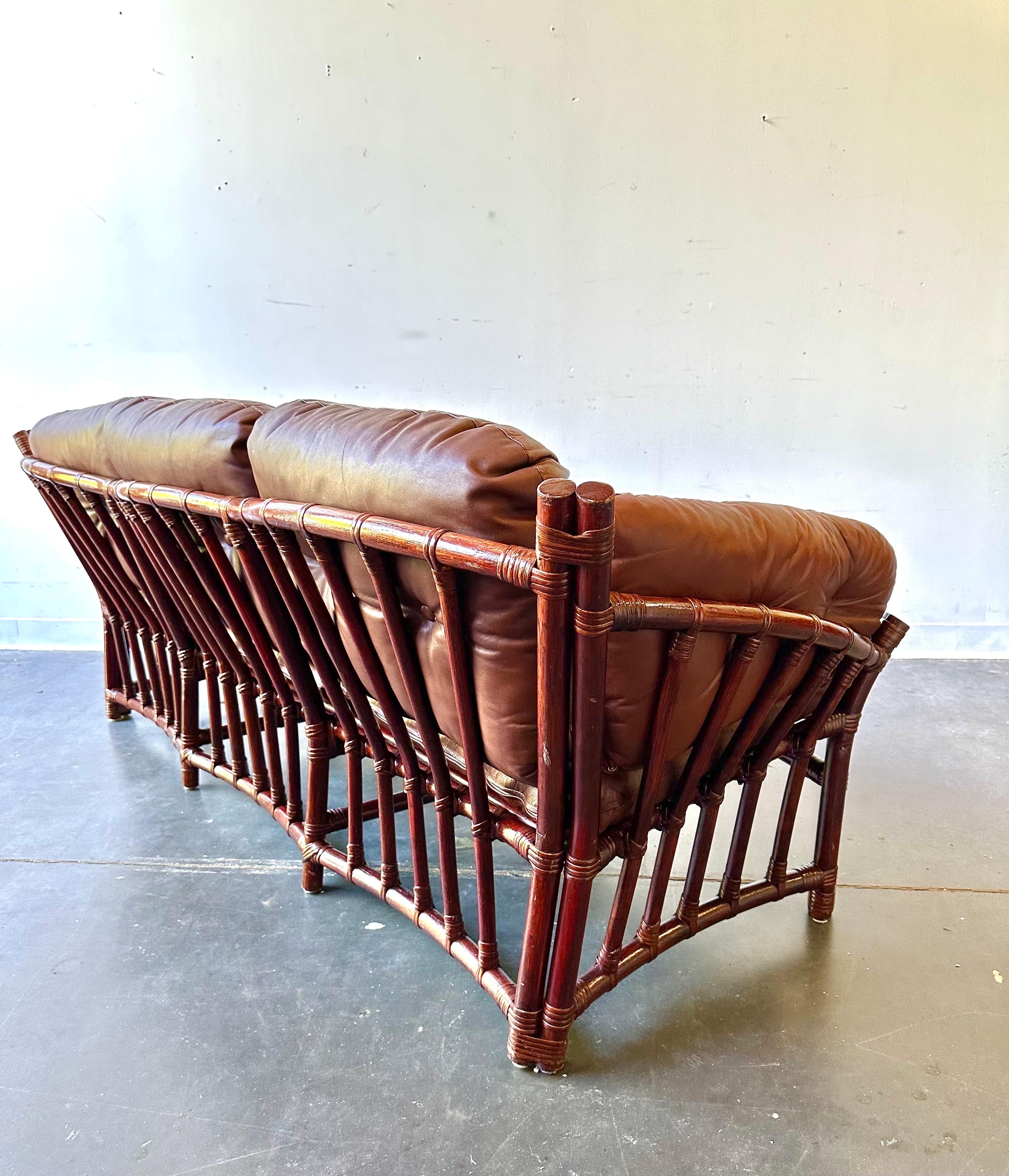 Leather and rattan sofa in the style of Percival Lafer 

Fantastic sofa in great shape ( only minor signs of wear to frame and leather ) 

Maker unknown but the leather is top notch.

Dimensions:

72” L x 33” x 28” H
Seat height is 17”