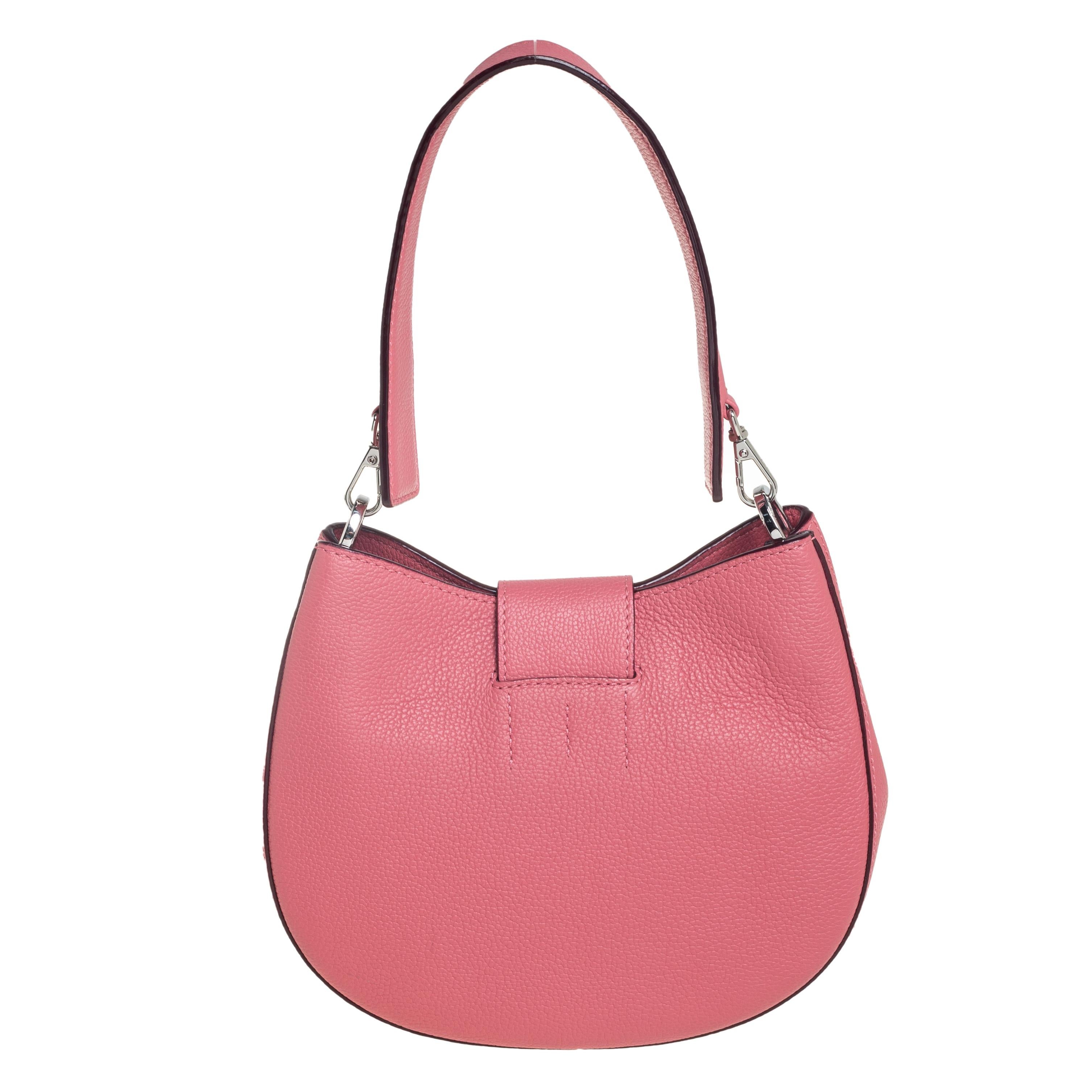 Complete your casual look with this stylish MCM Patricia hobo. It is made with pink leather and comes with a detachable shoulder strap. The front flap opens to a spacious interior lined with Alcantara. The engraved, silver-tone lock at the front
