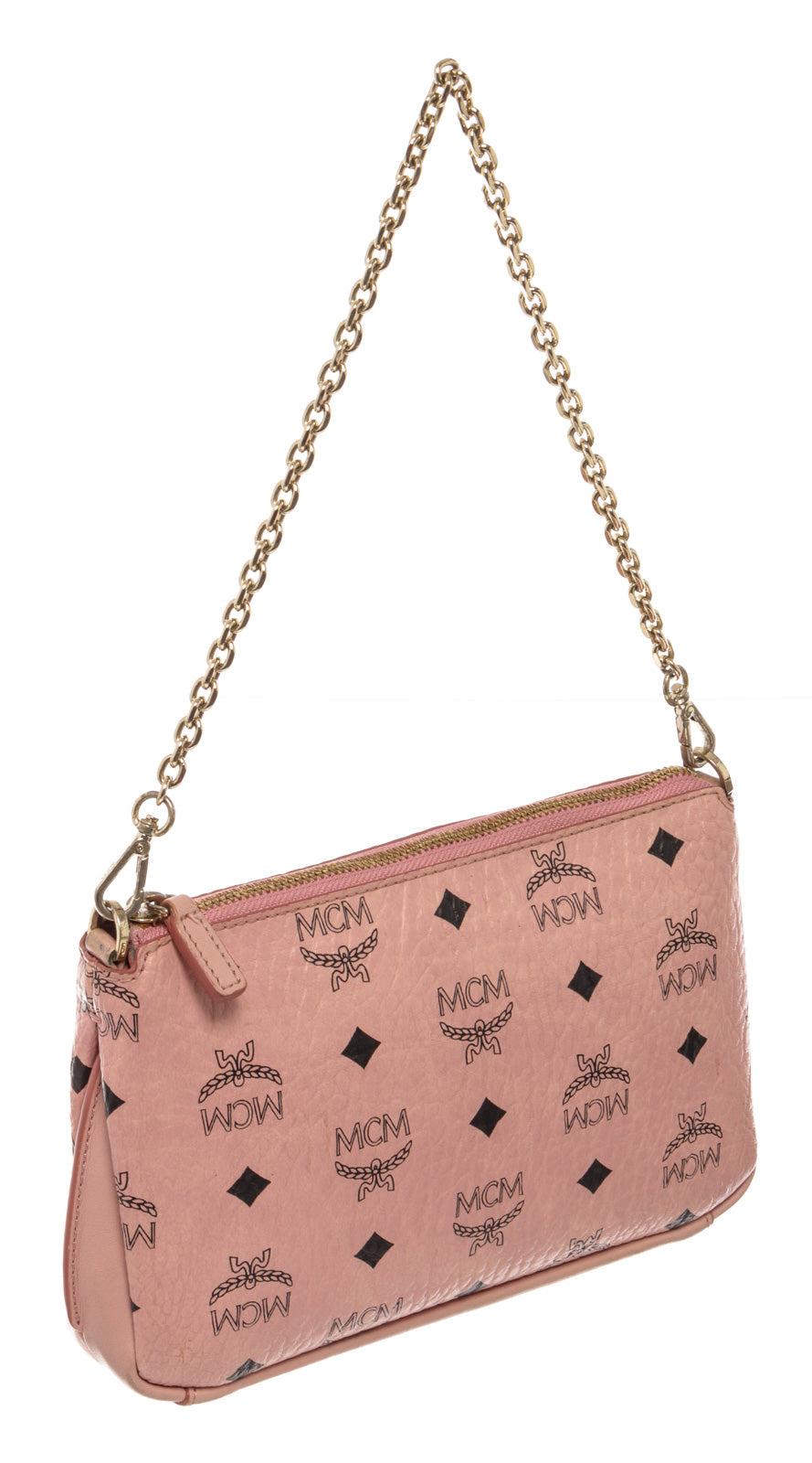 MCM Millie Top Zip small shoulder bag is crafted in soft pink Monogram Visetos coated canvas and beige canvas lining with slip pocket inside. This small bag is the perfect piece for finishing off a hip ensemble. The gold-tone hardware is blended