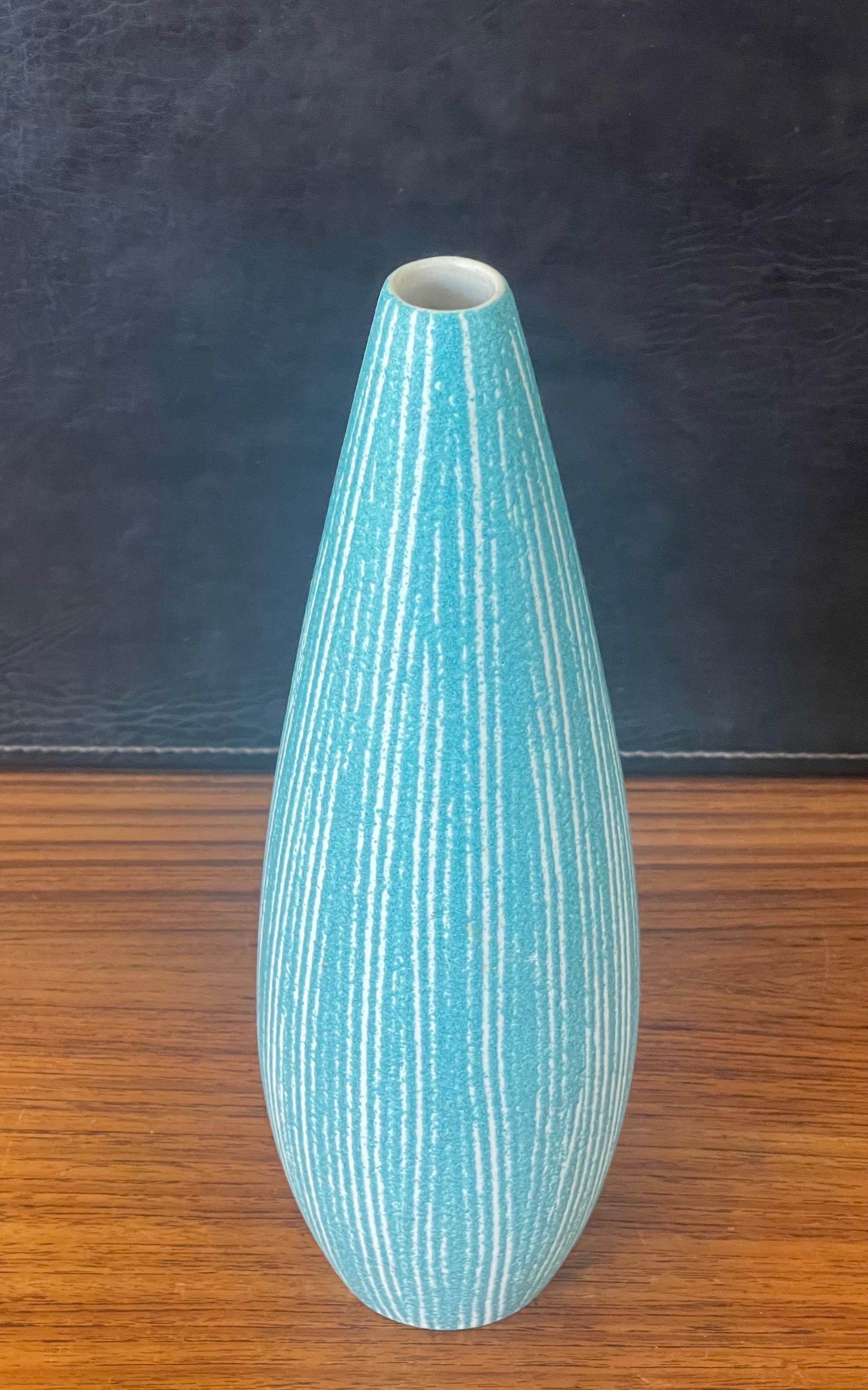 A very fun MCM powder blue ceramic vase by Hyalyn, circa 1960s. The vase is made of ceramic and is in very good condition with no chips or cracks; it measures 4