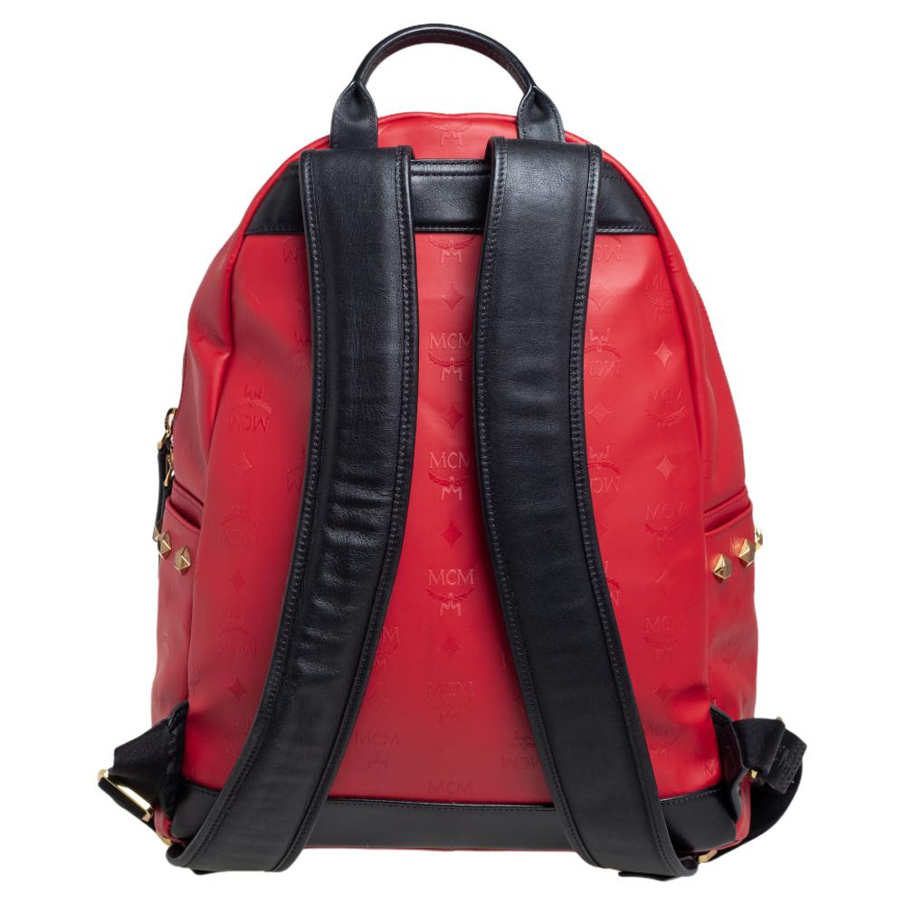 This stunning MCM backpack will come in handy for daily use or as a style statement. It is crafted from coated canvas and leather and designed with stud embellishments, a front pocket, and a spacious interior secured by a zipper. Two shoulder straps