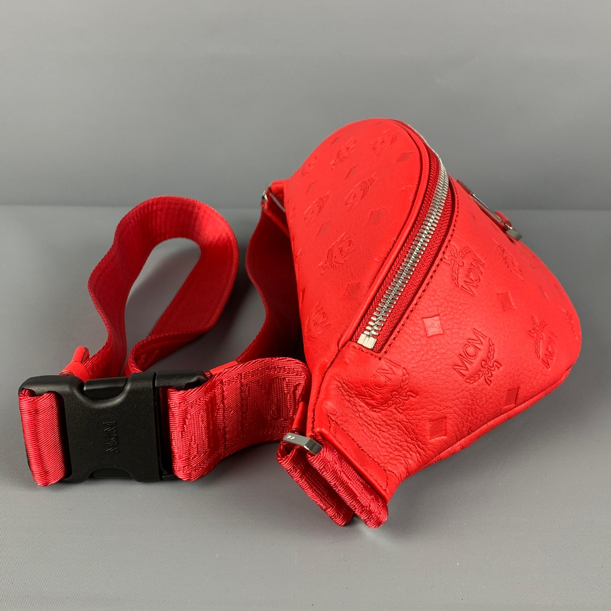 MCM belt pack comes in a red embossed monogram leather featuring a adjustable nylon strap, silver tone hardware, and a zipper closure. Comes with dust bag. 

New Without Tags. 
Original Retail Price: $640.00

Measurements:

Length: 16 in.
Width: