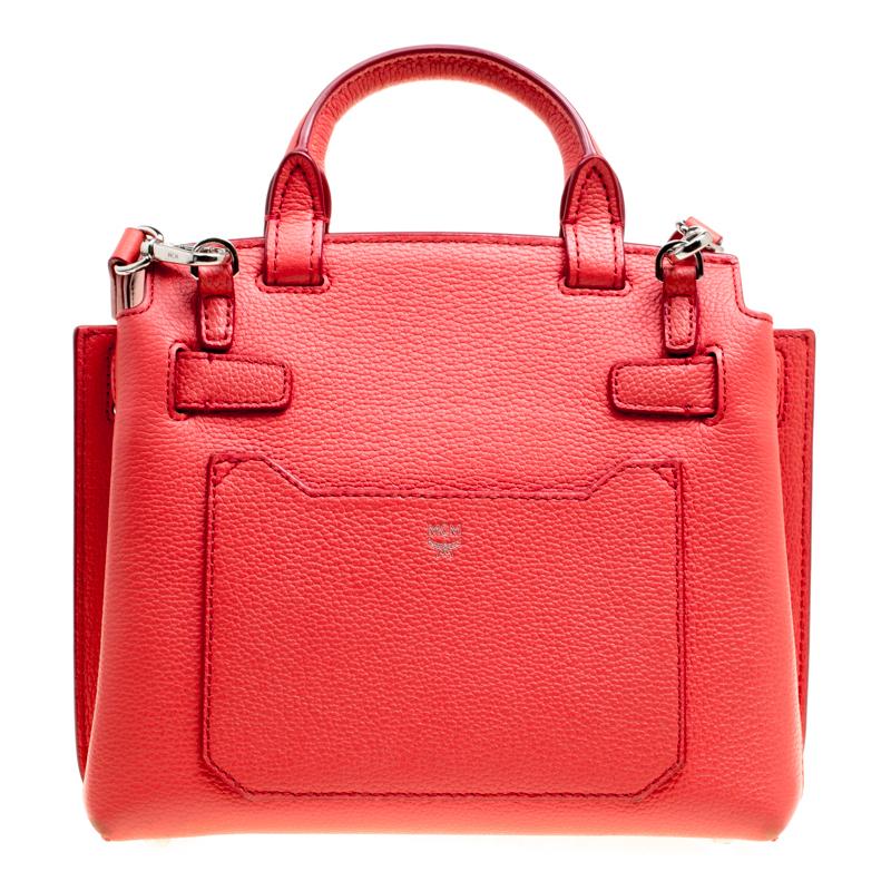 How elegant and lovely does this bag from MCM look! The red bag is crafted from leather and features a top handle, a detachable shoulder strap, protective metal feet and a front flap closure with a silver-tone twist lock. It opens to a Alcantara