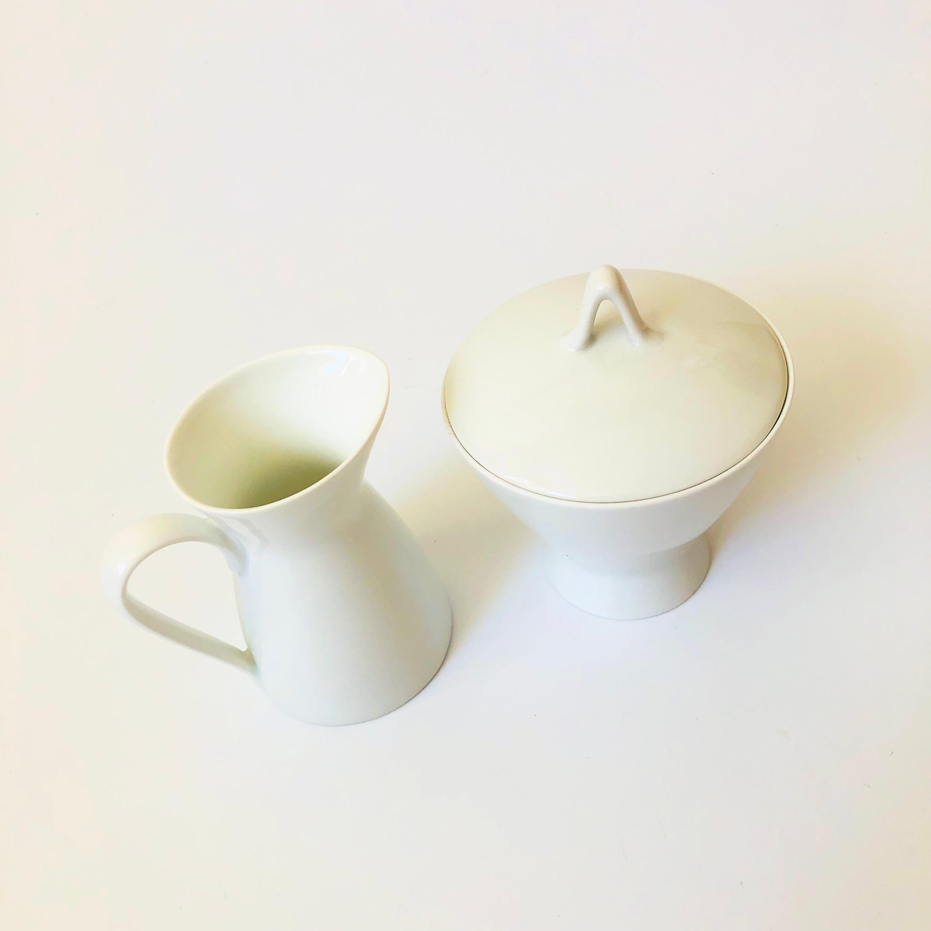 A mid century porcelain creamer and lidded sugar bowl set from the 