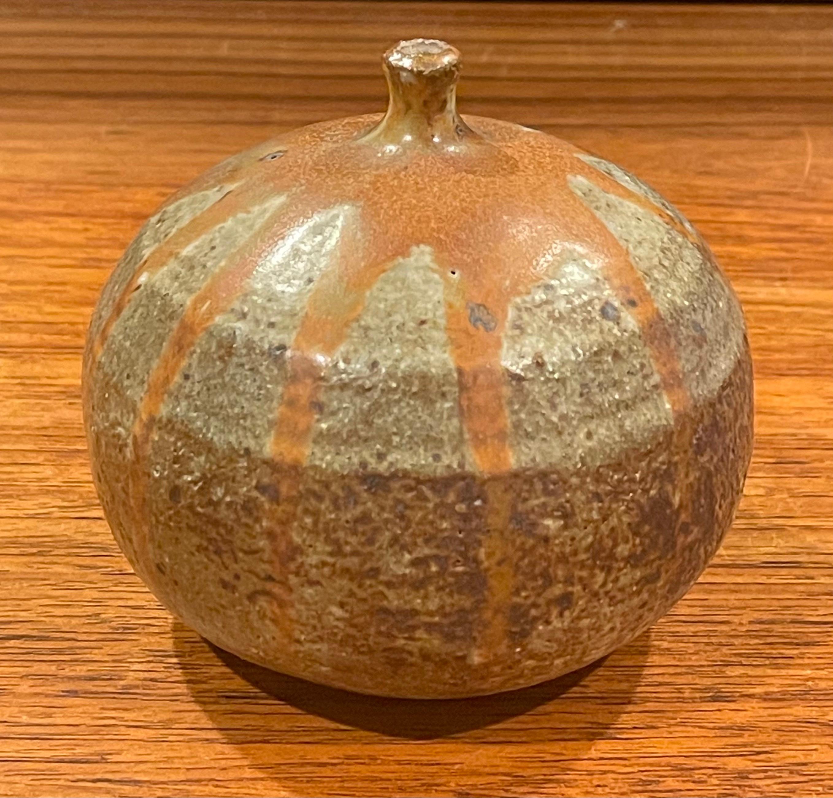 MCM round earthenware signed bud vase, circa 1970s. This vase is in excellent used condition with no chips or cracks and measures 4.5