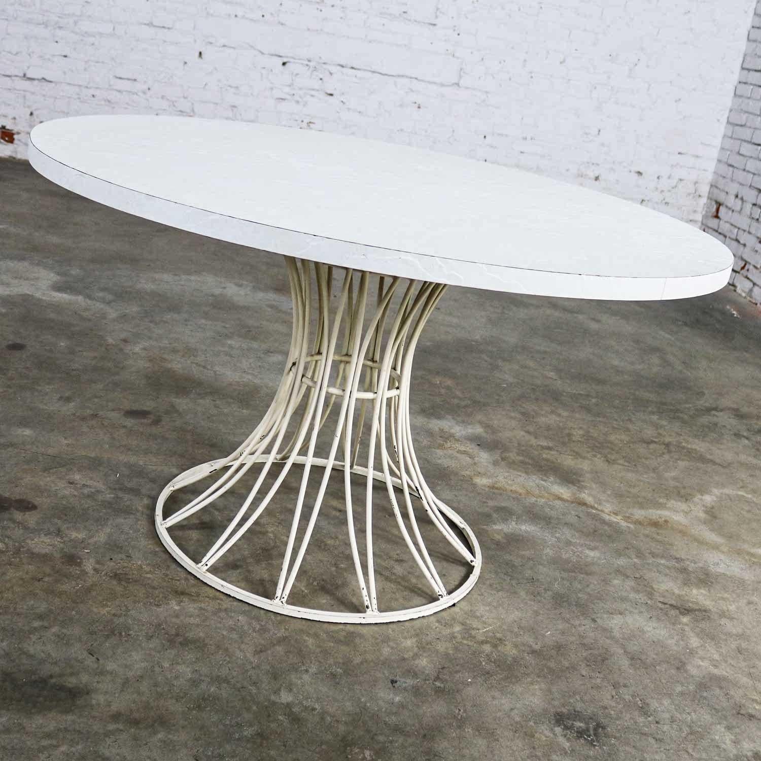 Wonderful Mid-Century Modern round white wrought iron patio table base with white slate-like textured laminate top by Max Stout for Blacksmith Shop Collection. Beautiful condition, keeping in mind that this is vintage and not new so will have signs