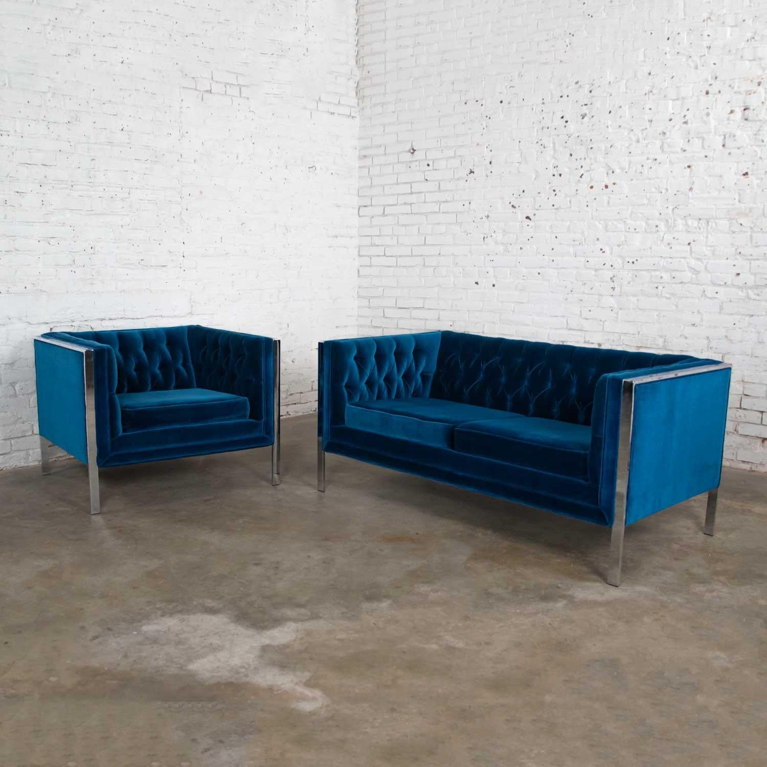 Gorgeous MCM royal blue velvet and chrome cube loveseat and chair after Milo Baughman. Comprised of a chrome frame and tufted button or button tuck inner arms and seat backs. Beautiful vintage condition. There are a few places where you can see wear
