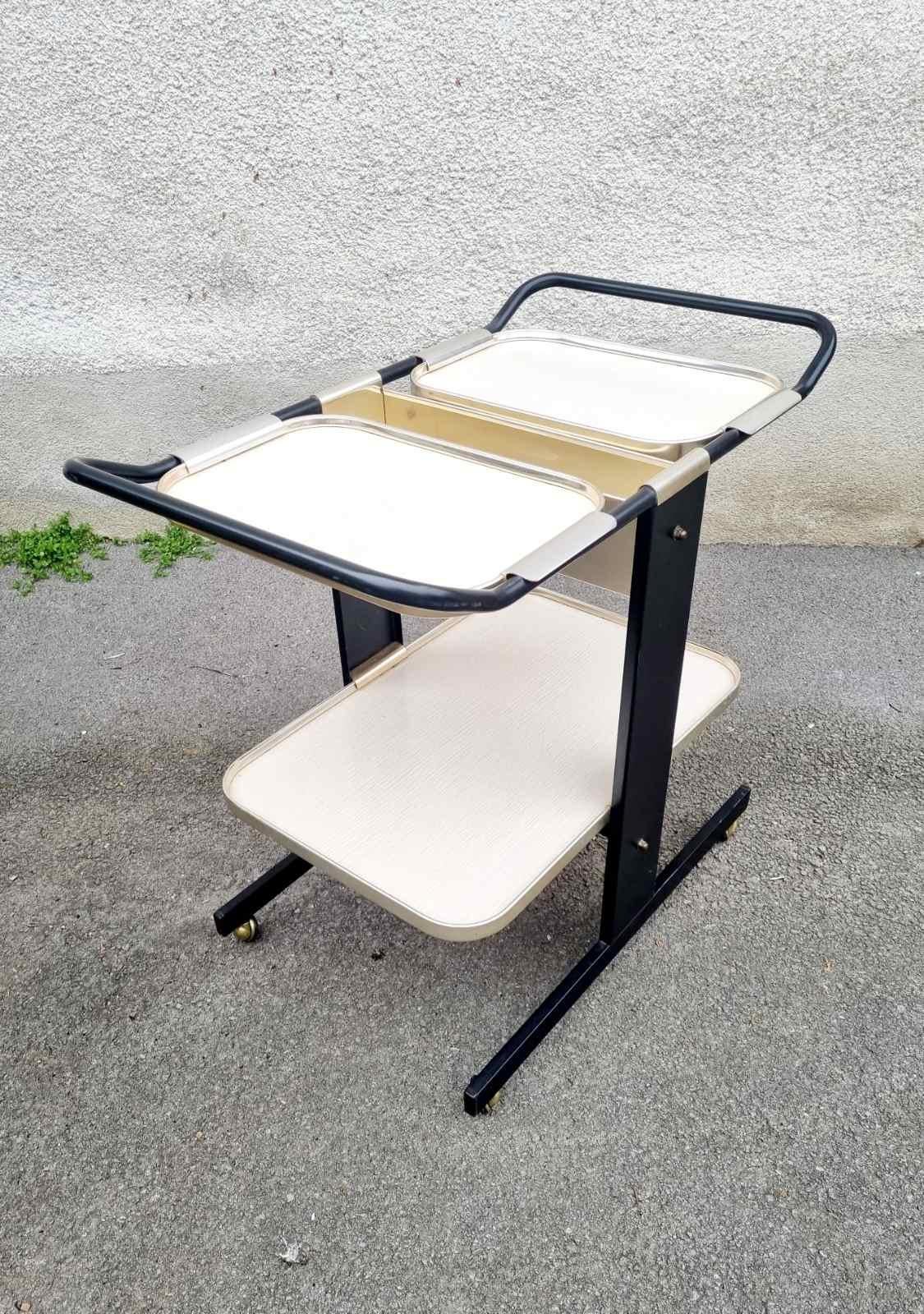 Very beautiful and stylish Serving Trolley was designed by Ico Parisi for MB Italia in '70s.
This piece of furniture is quite versatile and practical. It is made of aluminum frame and light beige shelves / trays.

It can be used as a stand for