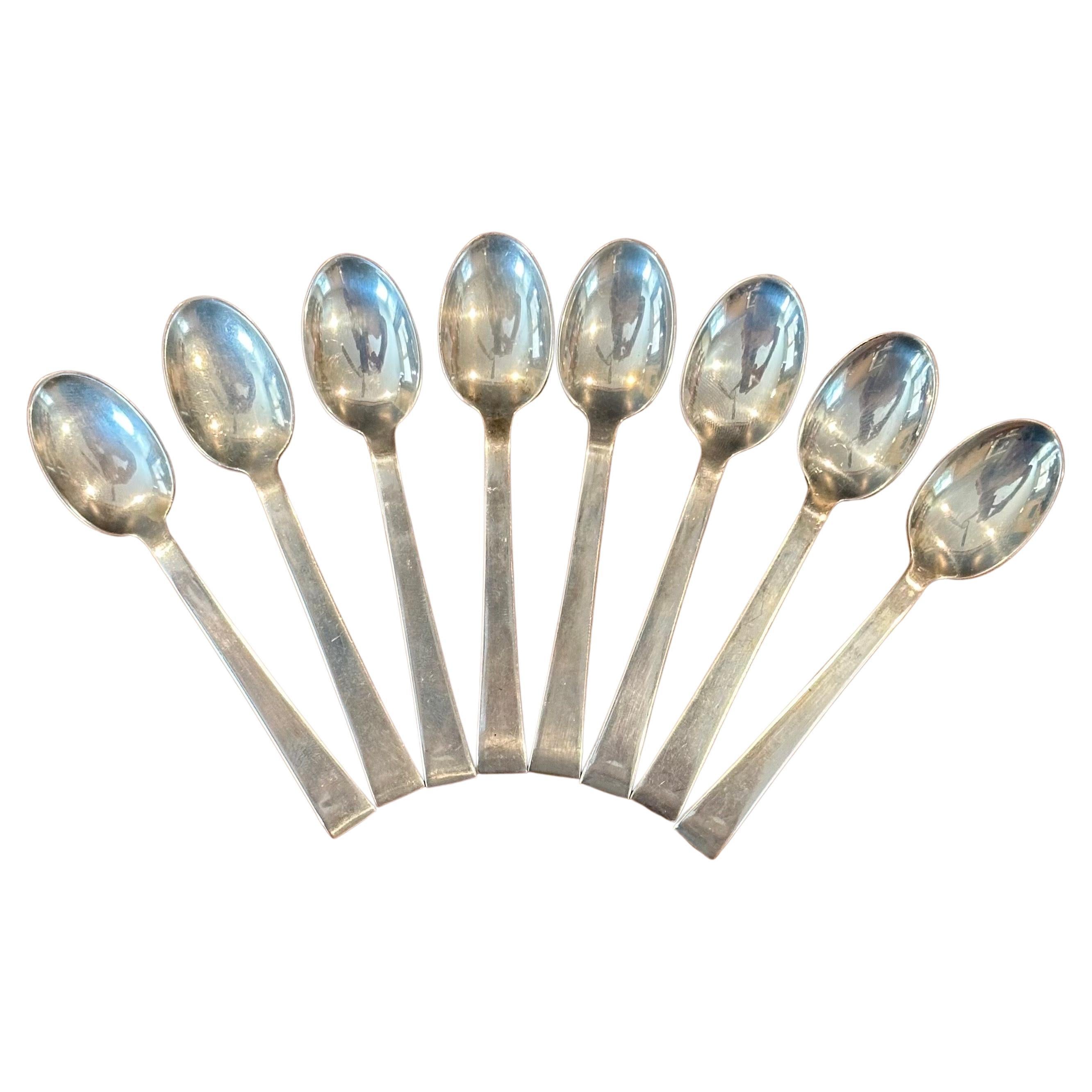 Simple and elegant stylized set of eight MCM demitasse spoons in sterling silver by International Silver, circa 1970s. The set is in very good vintage condition and each spoon measures .75