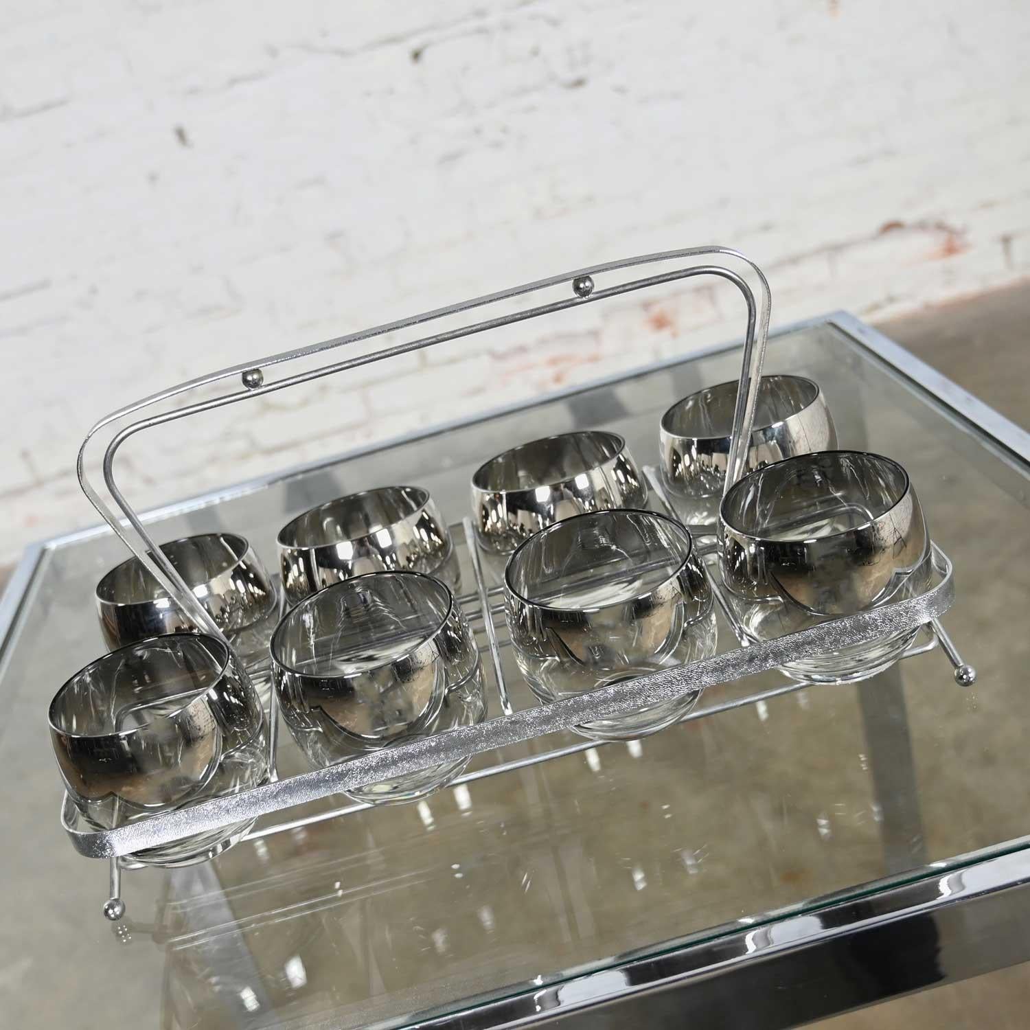 Just WOW! What a gorgeous chrome caddy filled with EIGHT stunning roly poly silver rimmed cocktail glasses!! What a sophisticated set of glassware to impress your guests! The chrome carrier is ADORABLE! It is chrome with wonderful chrome sphere feet