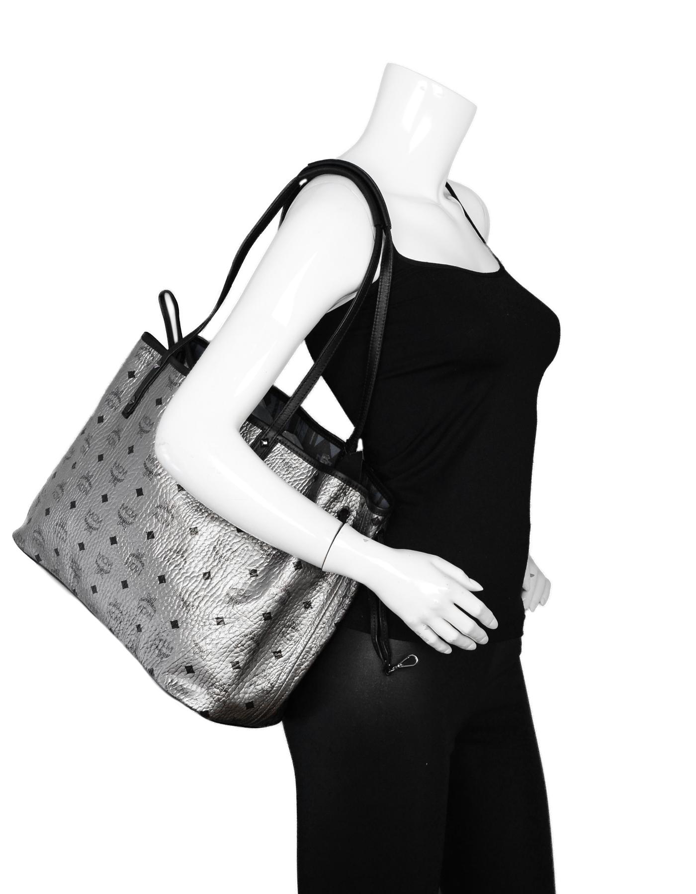 MCM Silver Monogram Coated Canvas Visetos Medium Reversible Shopper Tote Bag

Color: Silver
Hardware: Silvertone hardware
Materials: Coated canvas, leather trim
Lining: Blue monogram lining
Closure/Opening: Open top with drawstring closures to