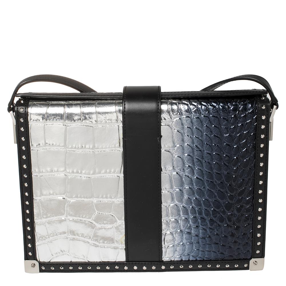 Visually cute and incredibly dashing, this croc-embossed patent leather & leather bag in a lovely silver ombre. This bag is lined with quality suede that allows you to keep your essentials safe. This fashionable bag by MCM will surely leave you