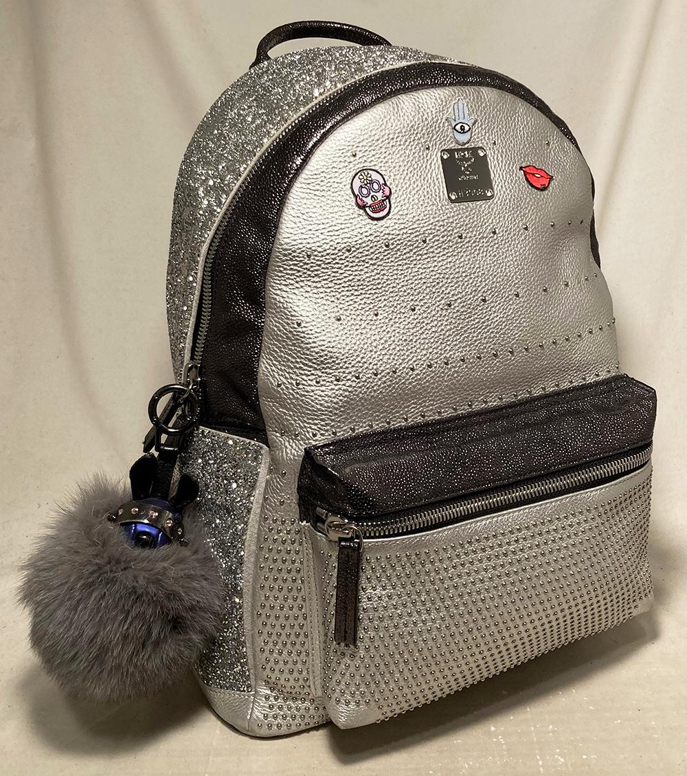 MCM Special Edition Silver Leather Swarovski Crystal Backpack with Rabbit Charm in excellent condition. Silver leather body with small silver studs trimmed with gunmetal caviar leather and swarovski crystals along sides. Front zippered pouch, small