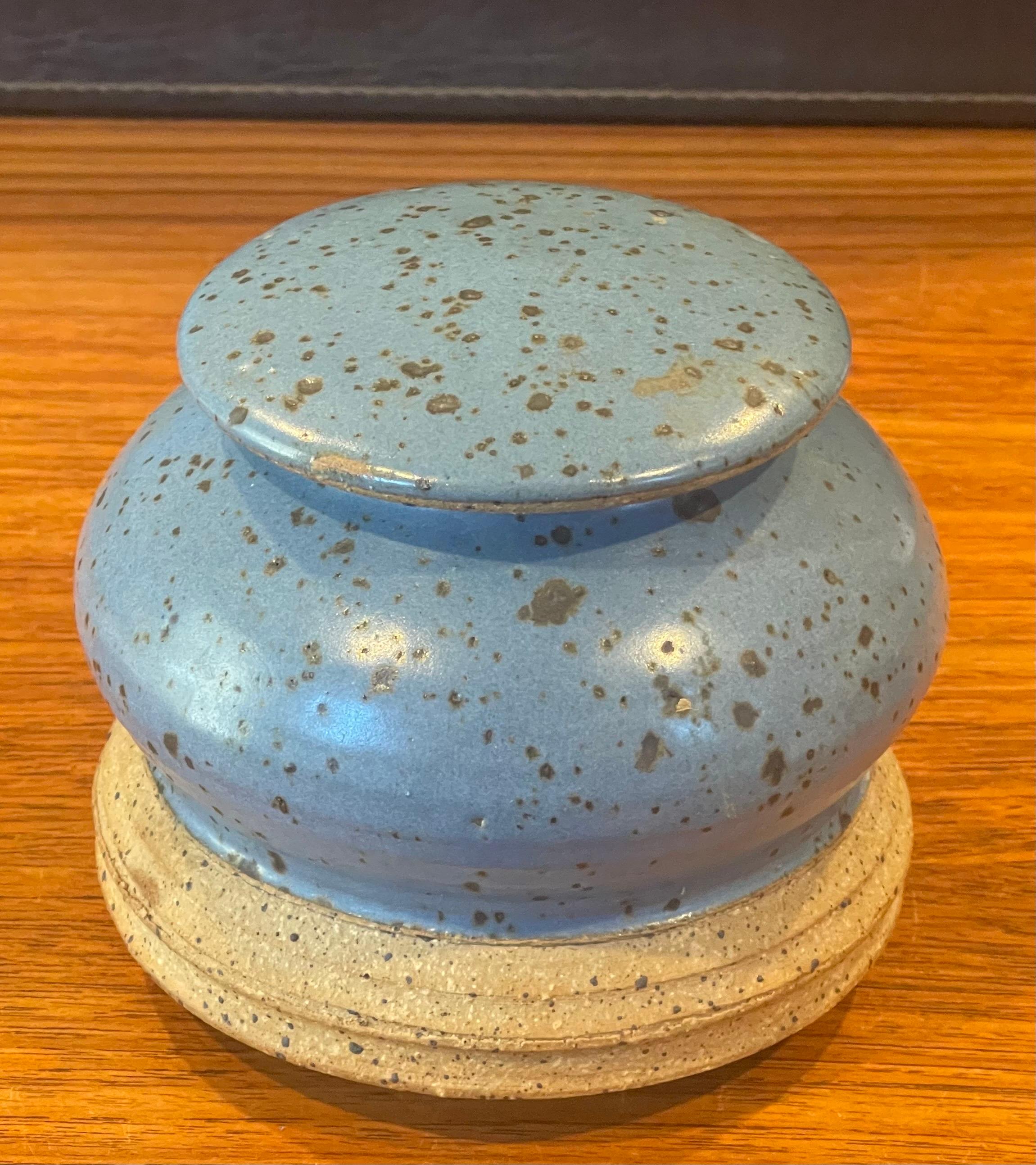 MCM stoneware studio pottery jar with lid, circa 1970s. This gorgeous hand finished jar has a wonderful design, texture and color. The piece measures 6