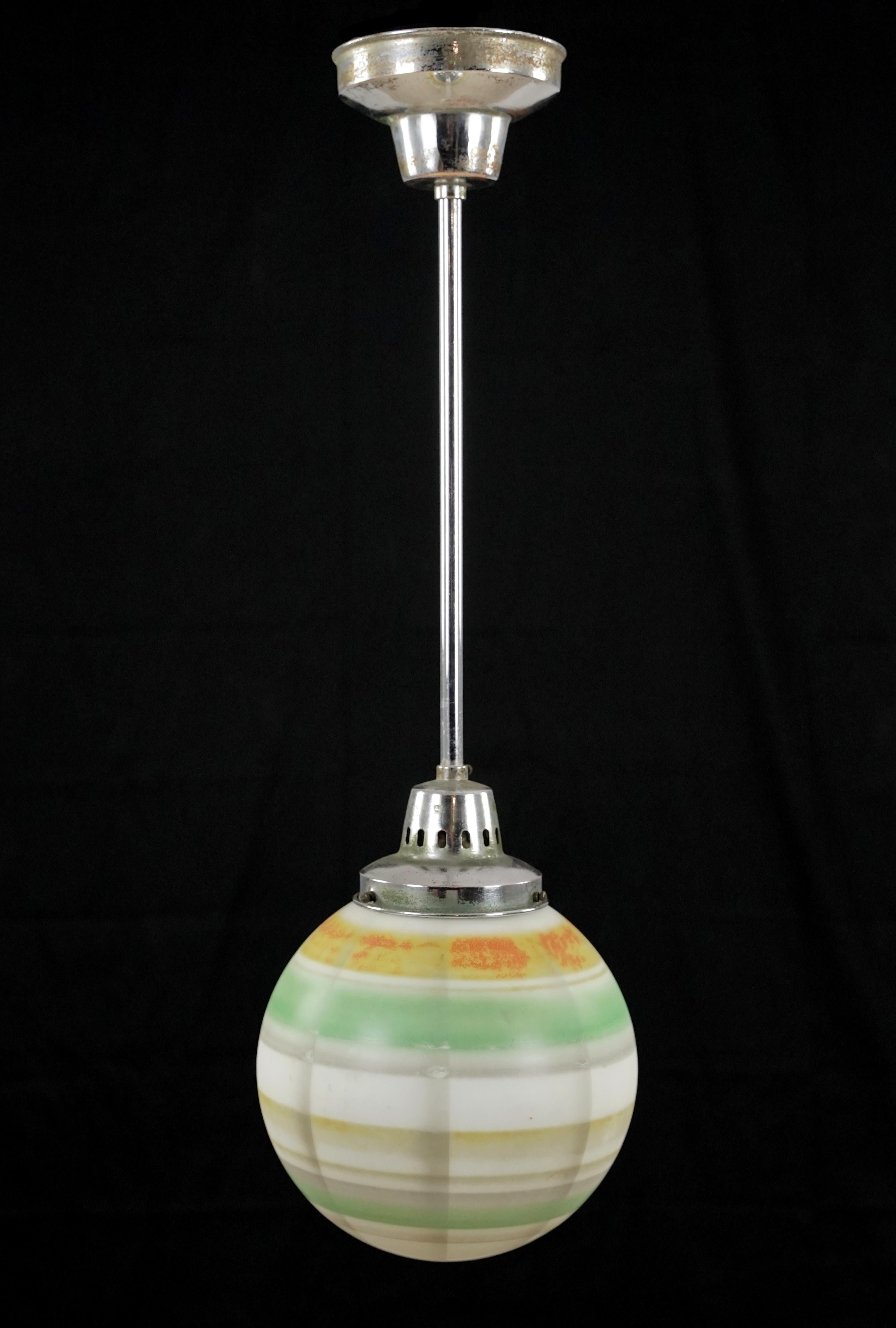 Mid-Century Modern style pendant light with a white, gray, green, orange, and tan striped globe paired with a nickel finish steel pole. This requires one standard Edison style medium base bulb. The price includes restoration of cleaning and