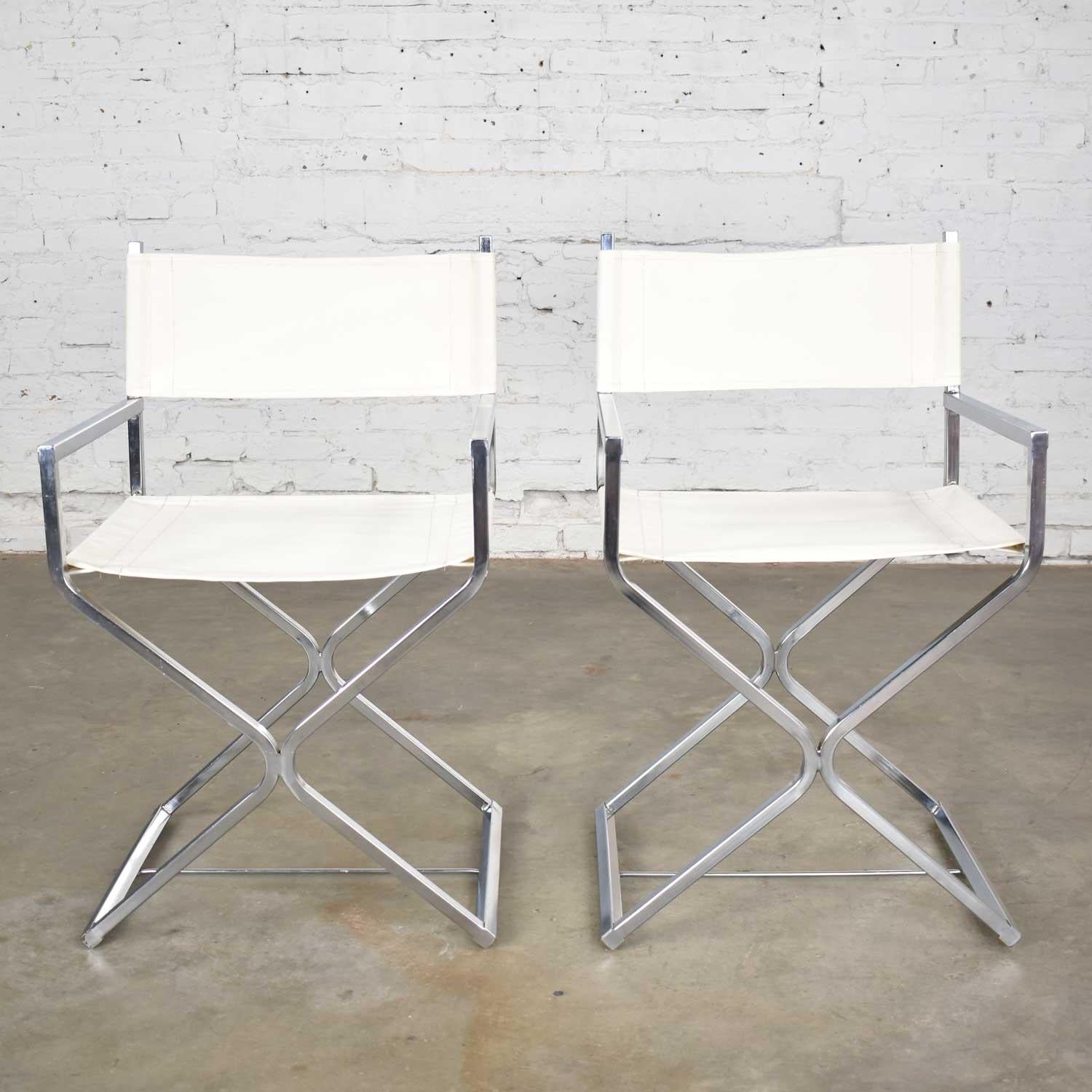 Gorgeous pair of MCM a.k.a. Mid-Century Modern Campaign style sling director’s chairs attributed to Robert Kjer Jakobsen for Virtue Brothers. They are in wonderful vintage condition. The sling’s have been newly upholstered in a white canvas. The