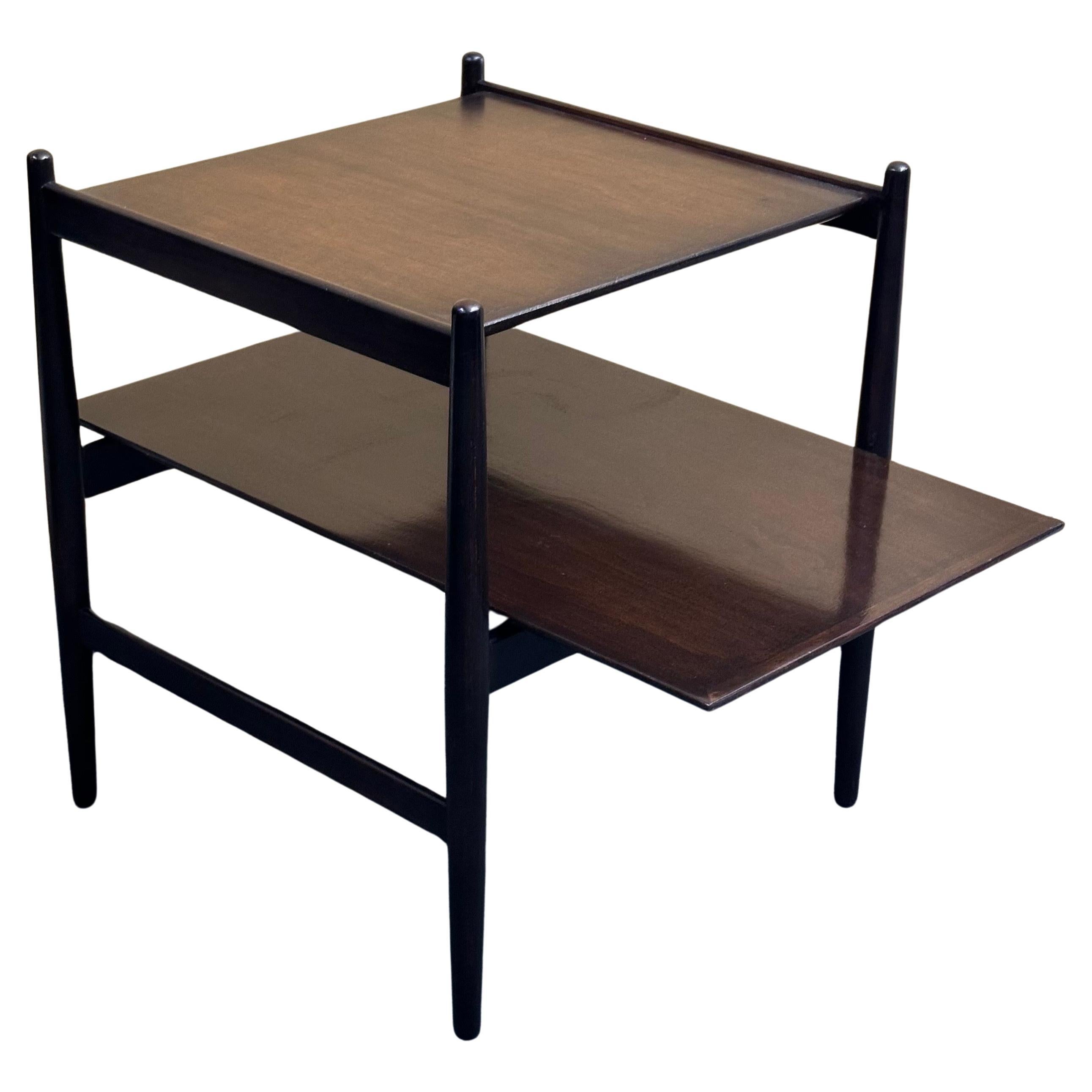 Fabulous MCM Sun Coast two-tier cantilever end table by Kipp Stewart for Drexel, circa 1960s. The piece is in very good refinished vintage condition (I believe the wood is cherry, but it has been professionally refinished with a walnut stain-looks