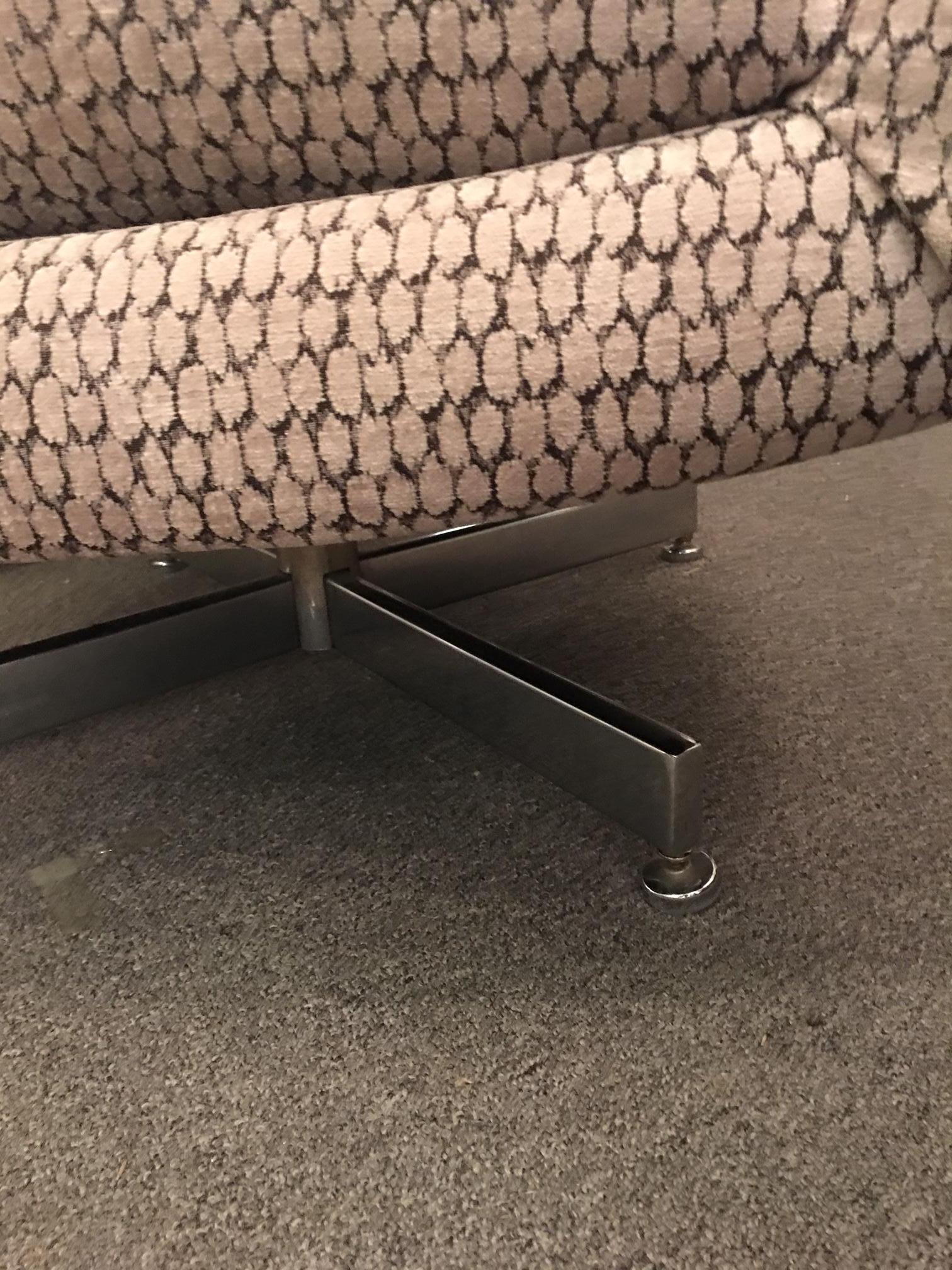 This midcentury chair has been newly upholstered in a soft and luxurious print that suggests and animal print but is really not. The colors are a soft beige backed with charcoal. Tufted back and sides. Excellent swivel mechanism in chrome. Note that