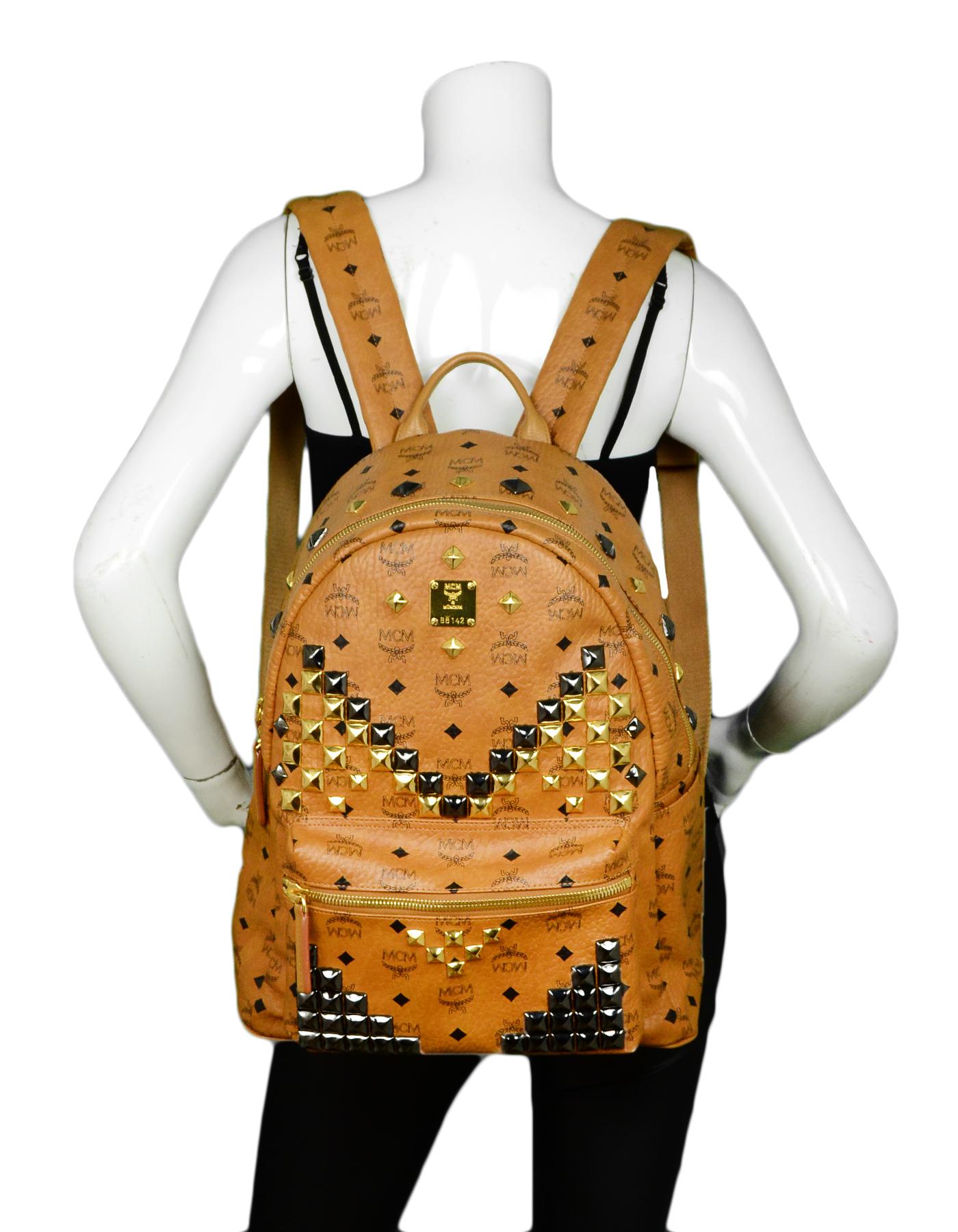 MCM Tan Monogram Star M Stud Large Backpack

Made In: Korea
Color: Tan
Hardware: Goldtone 
Materials: Leather
Lining: Fine leather textile
Closure/Opening: Top zip pocket 
Exterior Pockets: Front zip pocket, two flat pockets
Interior Pockets: Two