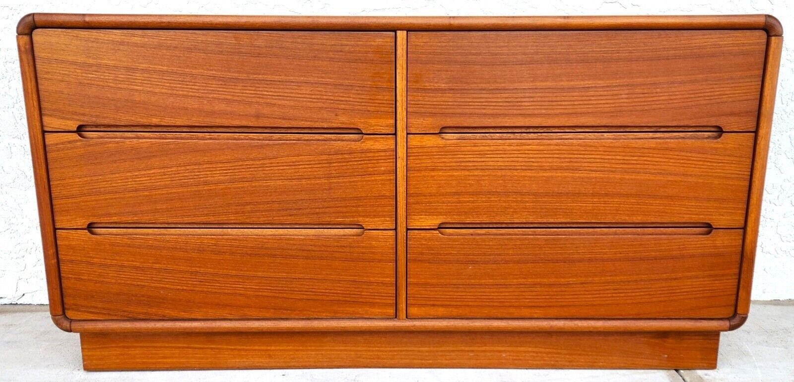 For FULL item description click on CONTINUE READING at the bottom of this page.

Offering One Of Our Recent Palm Beach Estate Fine Furniture Acquisitions Of A
MCM Teak Dresser by Sun Cabinet Co
Drawers are clean, work smoothly and are