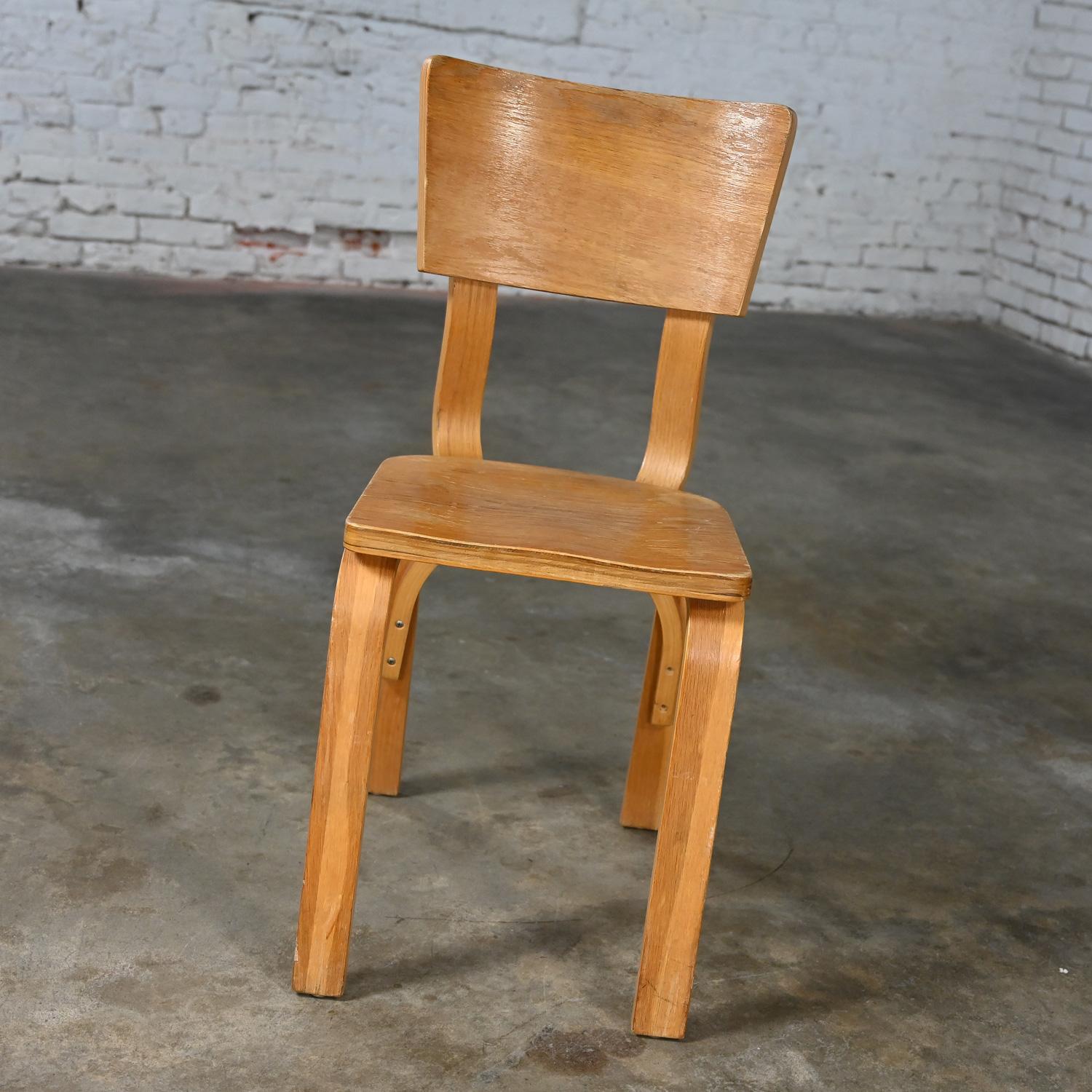 Handsome vintage Mid-Century Modern Thonet #1216-S17-B1 dining chairs comprised of bent oak plywood with saddle seats and a single bow back stretcher 22 available, selling separately & priced per chair, as is condition. See note below regarding