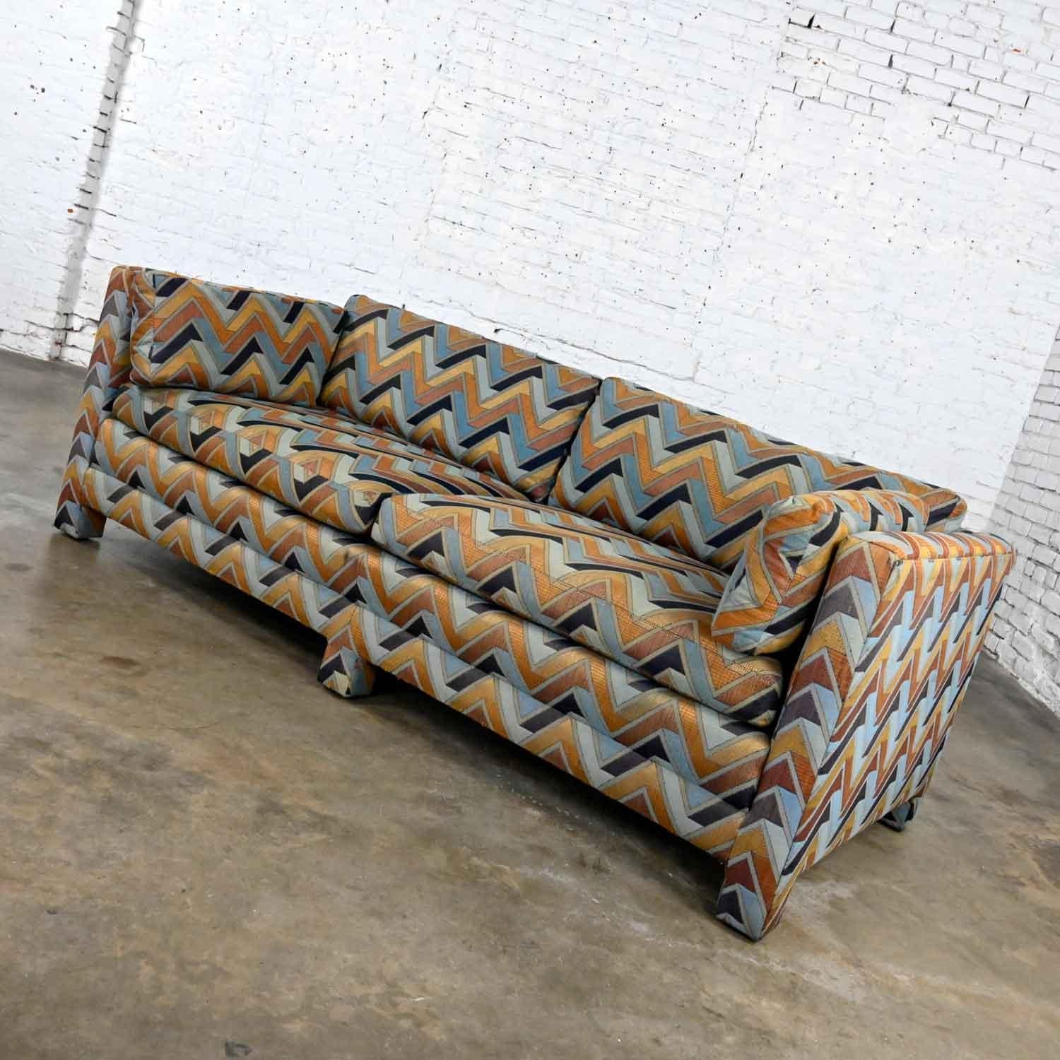 Fabulous MCM (a.k.a.) mid-century modern gray, light blue, navy blue, taupe, gold & rust chevron tuxedo cube sofa with upholstered legs and frame by Henredon style Milo Baughman. Beautiful condition, keeping in mind that this is vintage and not new